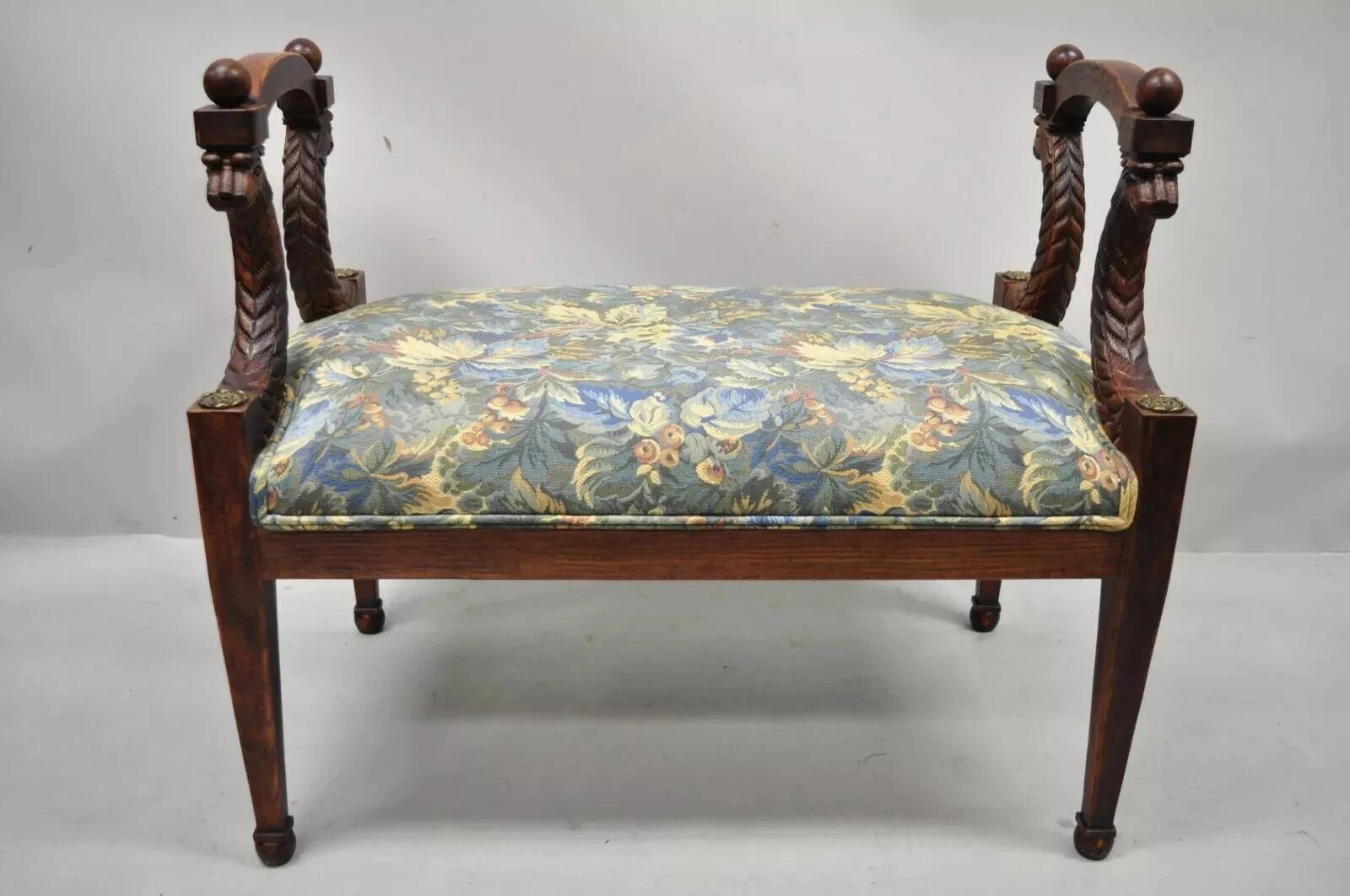 Vintage Italian Regency Style Figural Carved Floral Upholstered Wooden Window Bench. Item features faces carved to frame, distressed finish, and tapered legs. Circa Mid 20th Century. Measurements: 27