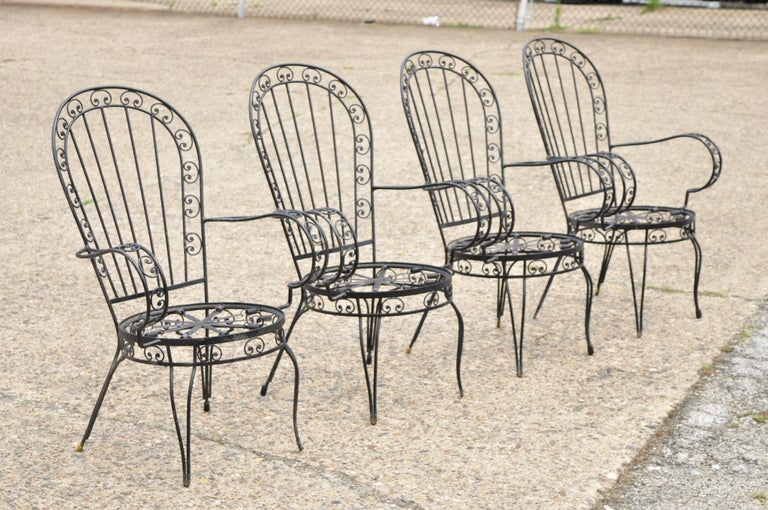 Vintage Italian Regency Style Wrought Iron Fan Back Sunroom Dining Arm Chairs - Set of 4. Set includes (4) arm chairs, round seats, fan backs, scrollwork design throughout, spring system seats, loose cushions, wrought iron construction, quality