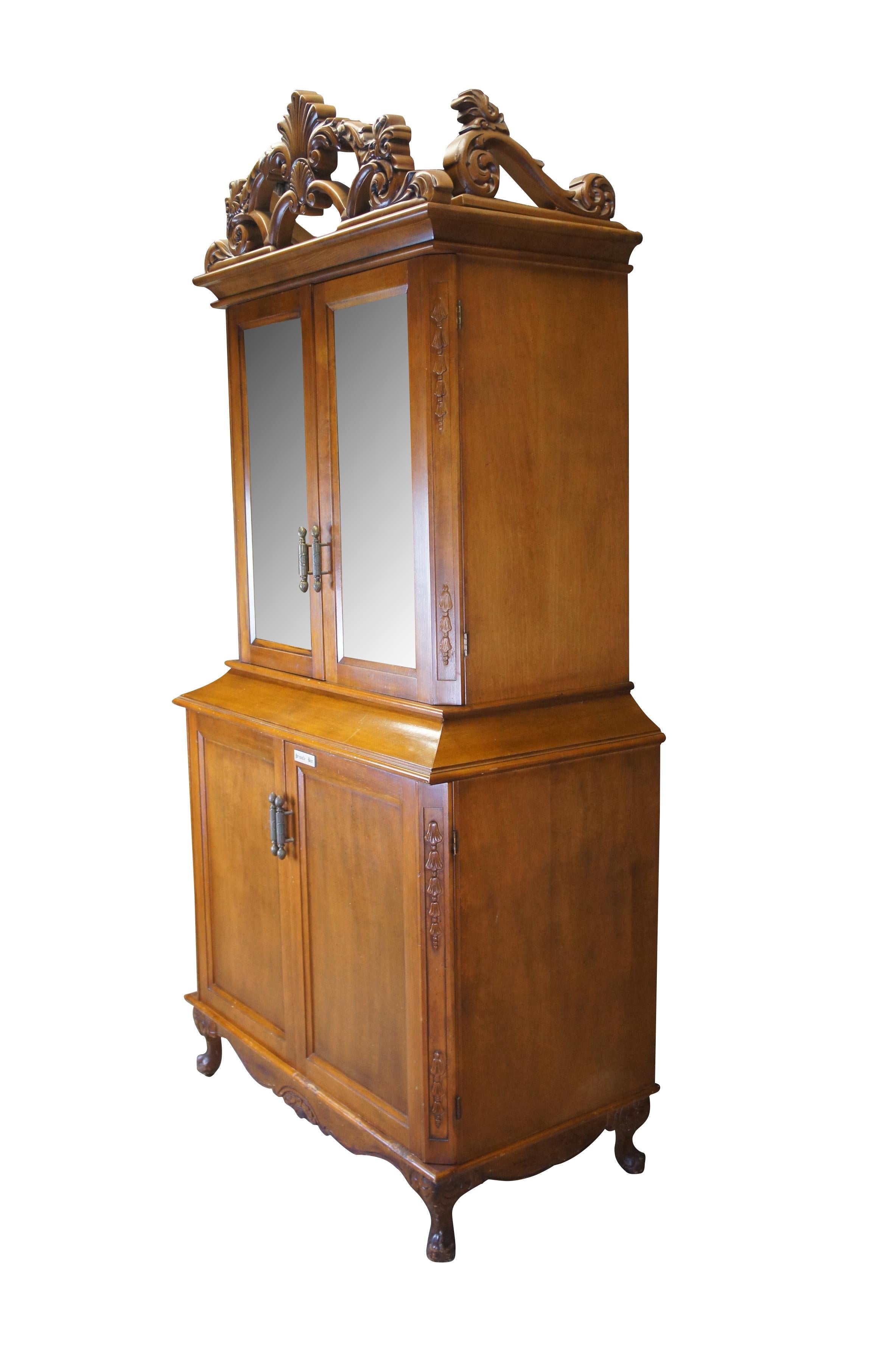 An impressive dry bar / tv cabinet reclaimed from The Plaza Hotel of NYC in the 1990s. Drawing inspiration from French and Italian styling. A tall case made from mahogany with mirrored beveled hutch doors. This stately piece would have been used