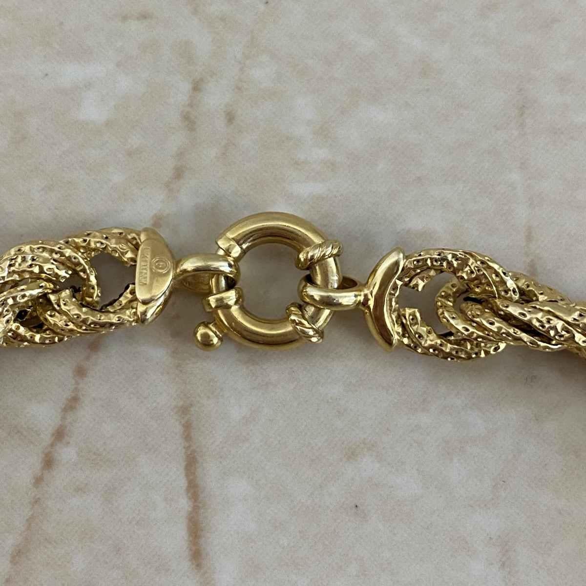 A beautiful vintage bracelet that exemplifies timeless elegance, this piece features an intricate rope design adorned with fine milgrain detailing throughout. Expertly handcrafted in rich 14k yellow gold, the bracelet reflects the exceptional