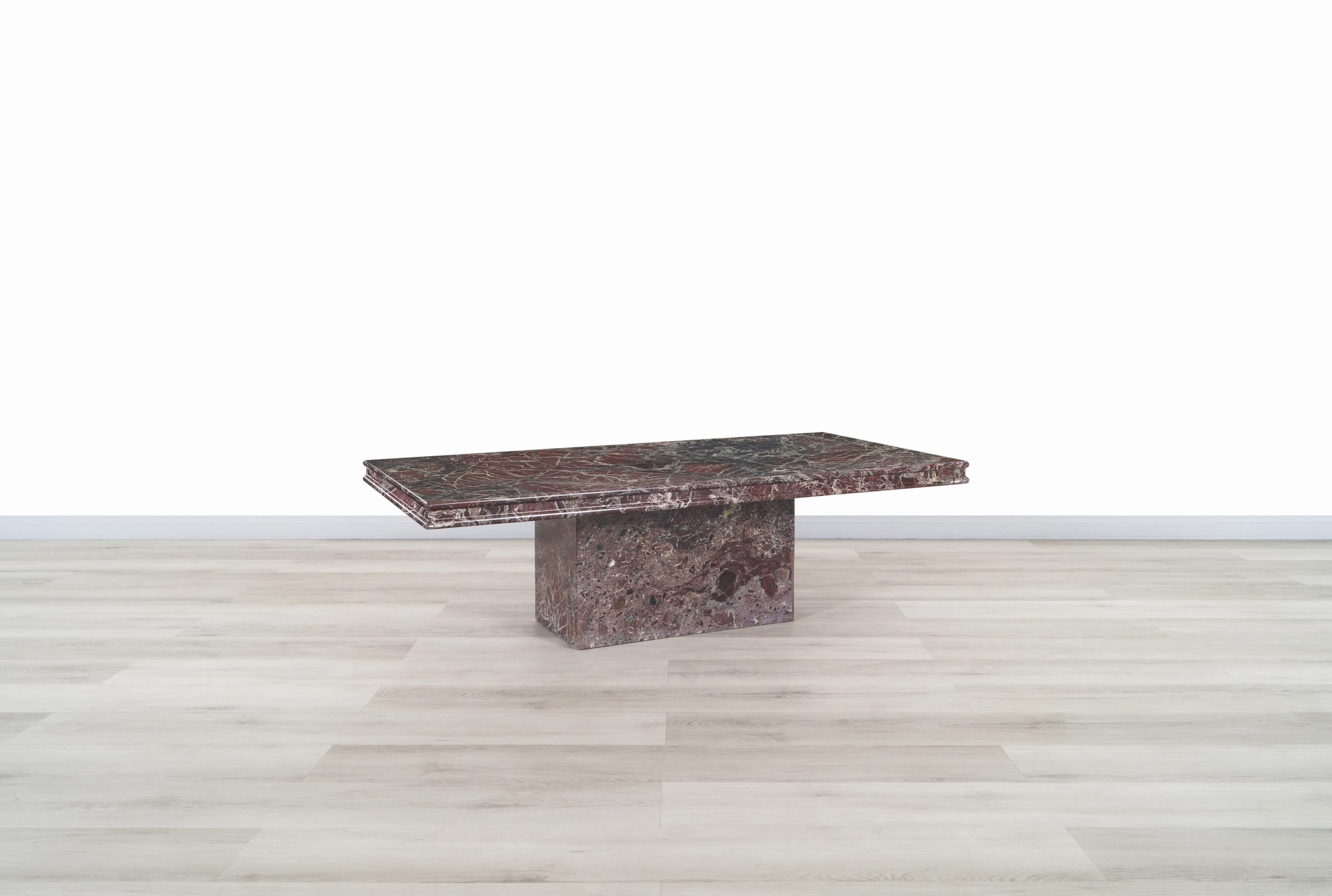 An amazing vintage marble coffee table manufactured in Italy, circa 1980s. The table is made out of an exotic Rosso Levanto marble. The top sits over an extremely sturdy base. Simple and Minimalist style along the rich veining and color combination