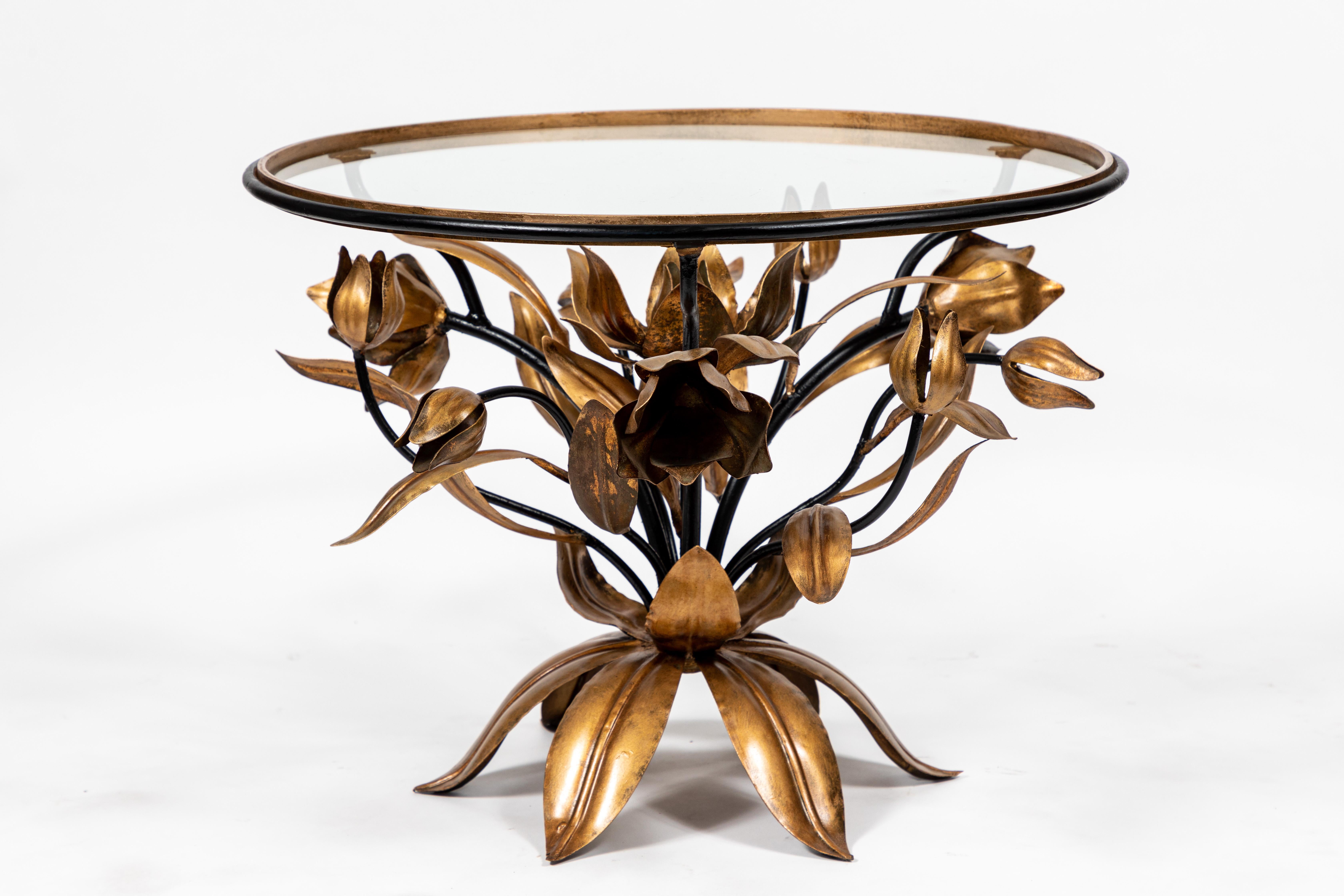 Vintage Italian round gilded gold and black painted metal tulip cocktail table with glass top.

Base is metal made up of flowers (tulips), branches and leaves with original black and gilded gold painted finish.