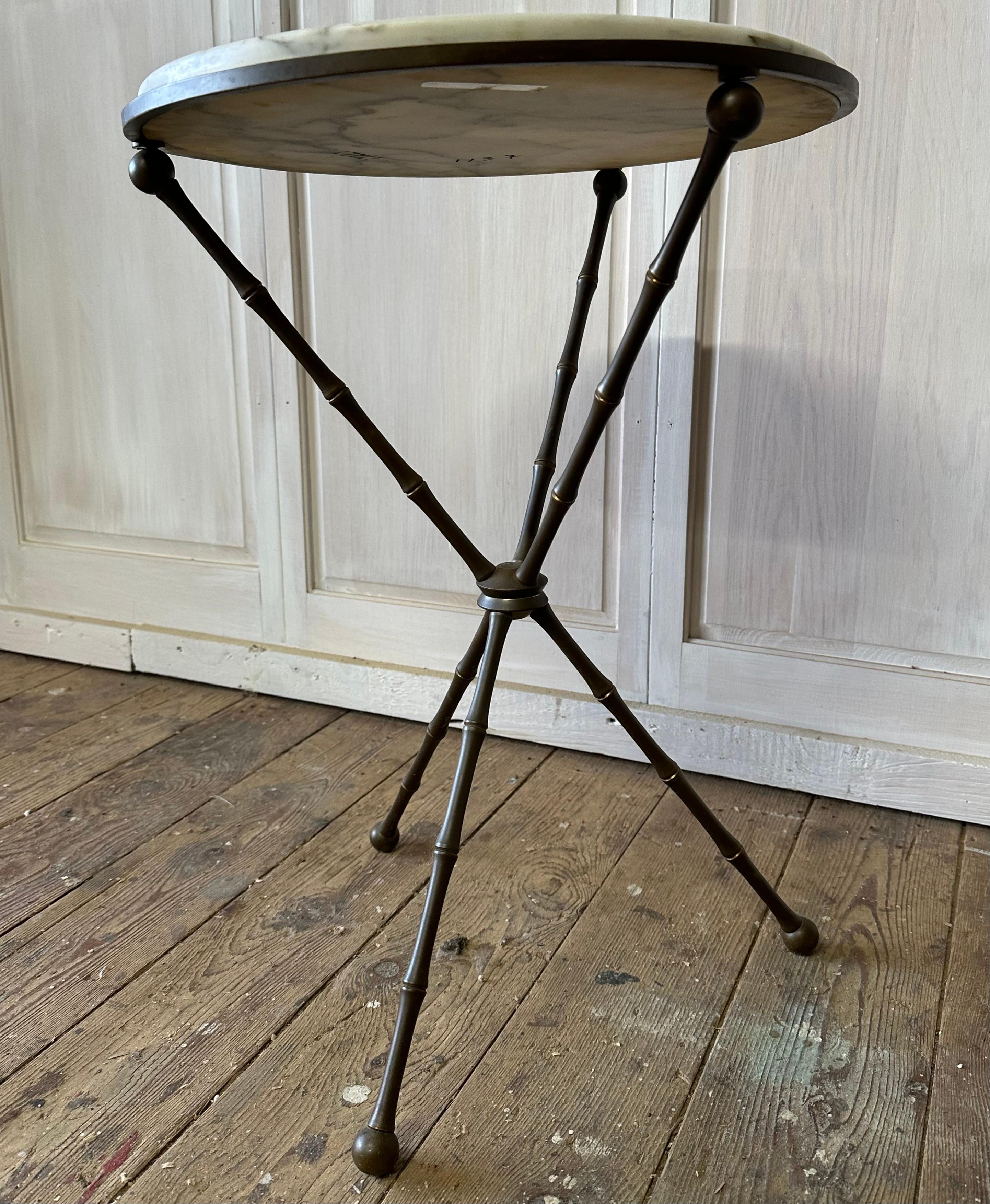 Round Italian white marble top sitting on tripod legs that have a faux bamboo design.  Can be used as a side table, end table, occasional wine table.
Mid-Century, Hollywood Regency
