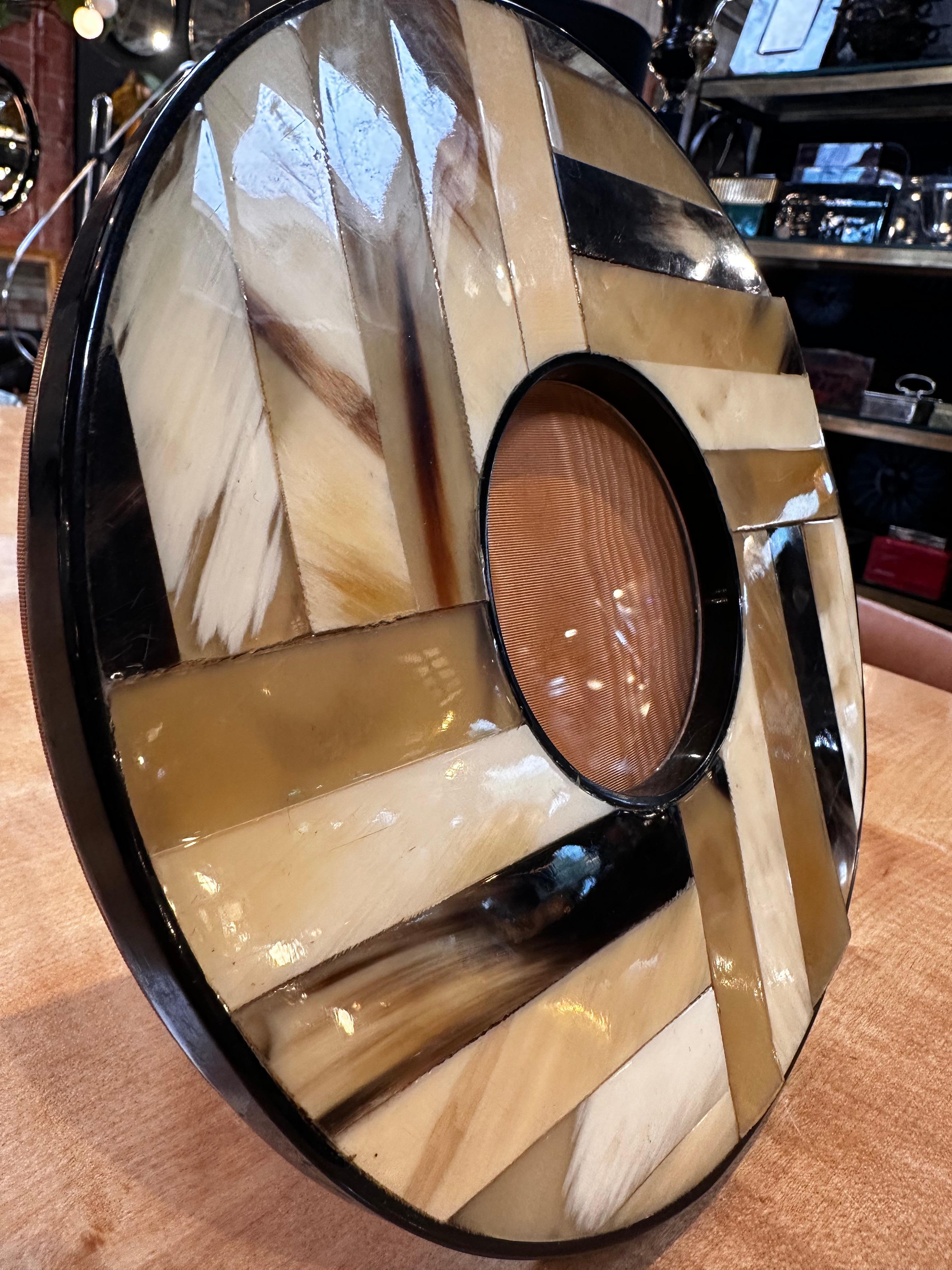 Step into a world of timeless elegance with our Vintage Italian Round Picture Frame from the 1980s. Meticulously crafted in Italy, this frame is a captivating fusion of wood and mother of pearl. The warm embrace of wood complements the iridescent