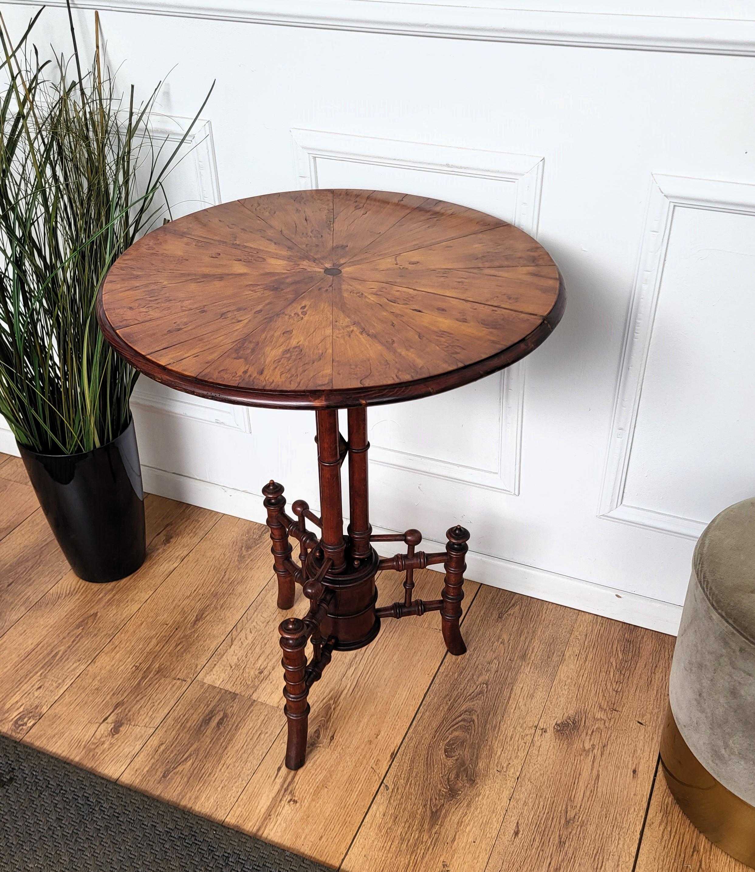 Beautiful antique Italian solid walnut side table features a round beveled top with veneer wood burl decor standing on the central beautifully carved tripod legs. This Italian walnut side or coffee table with the rich and beautiful patina would look