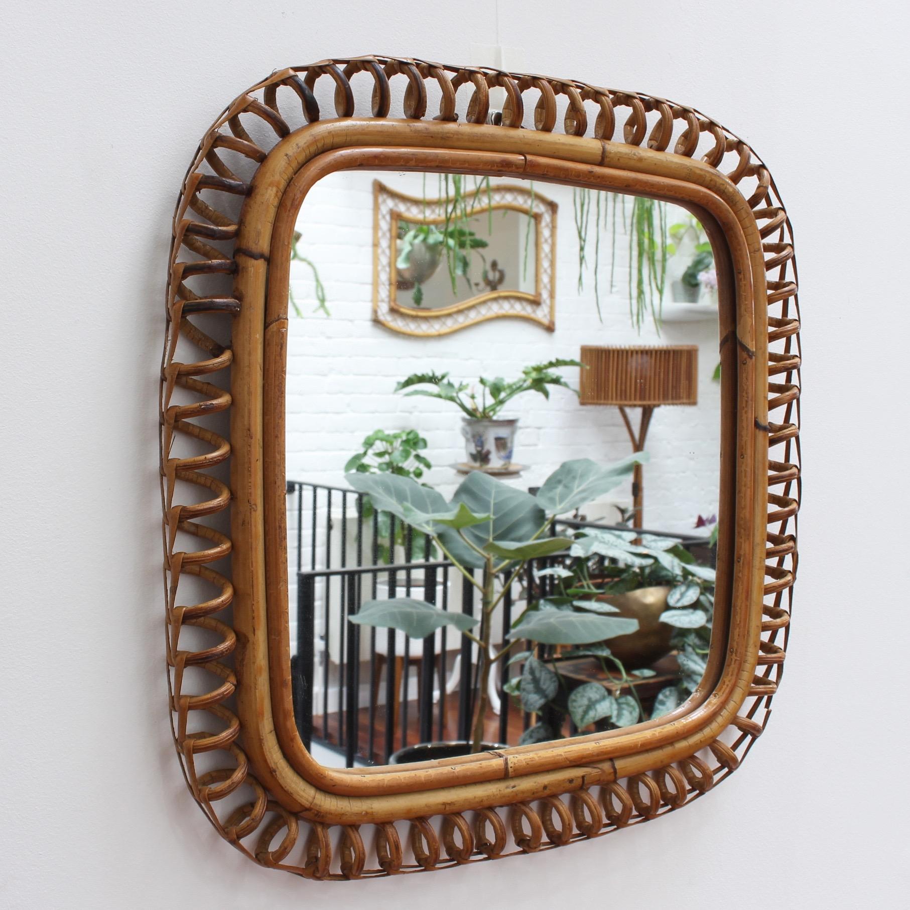 Vintage Italian rattan mirror (circa 1960s). Rarely available, this square shaped rattan mirror is a real find. The square frame is decorated on the surround with coiled bamboo reminiscent of old telephone cord. Filled with character and sunshine it