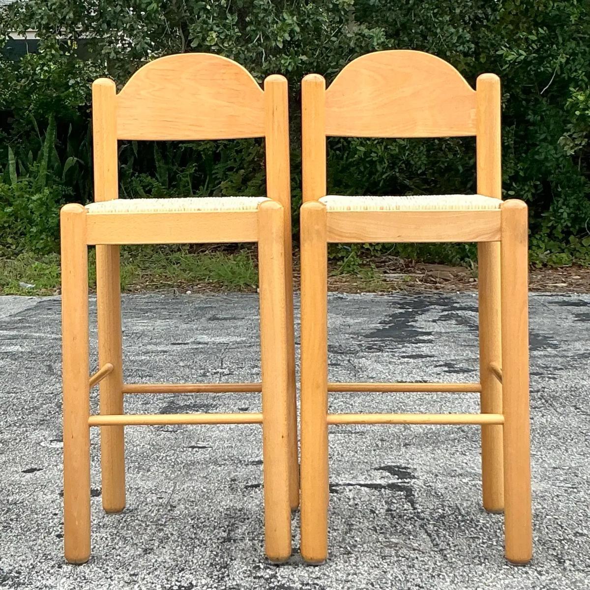 Elevate your dining or bar area with this charming set of Vintage Italian Rush Seat Padova Barstools. Expertly crafted in Italy, these stools feature a classic design with sturdy wooden frames and beautifully woven rush seats, embodying a rustic yet