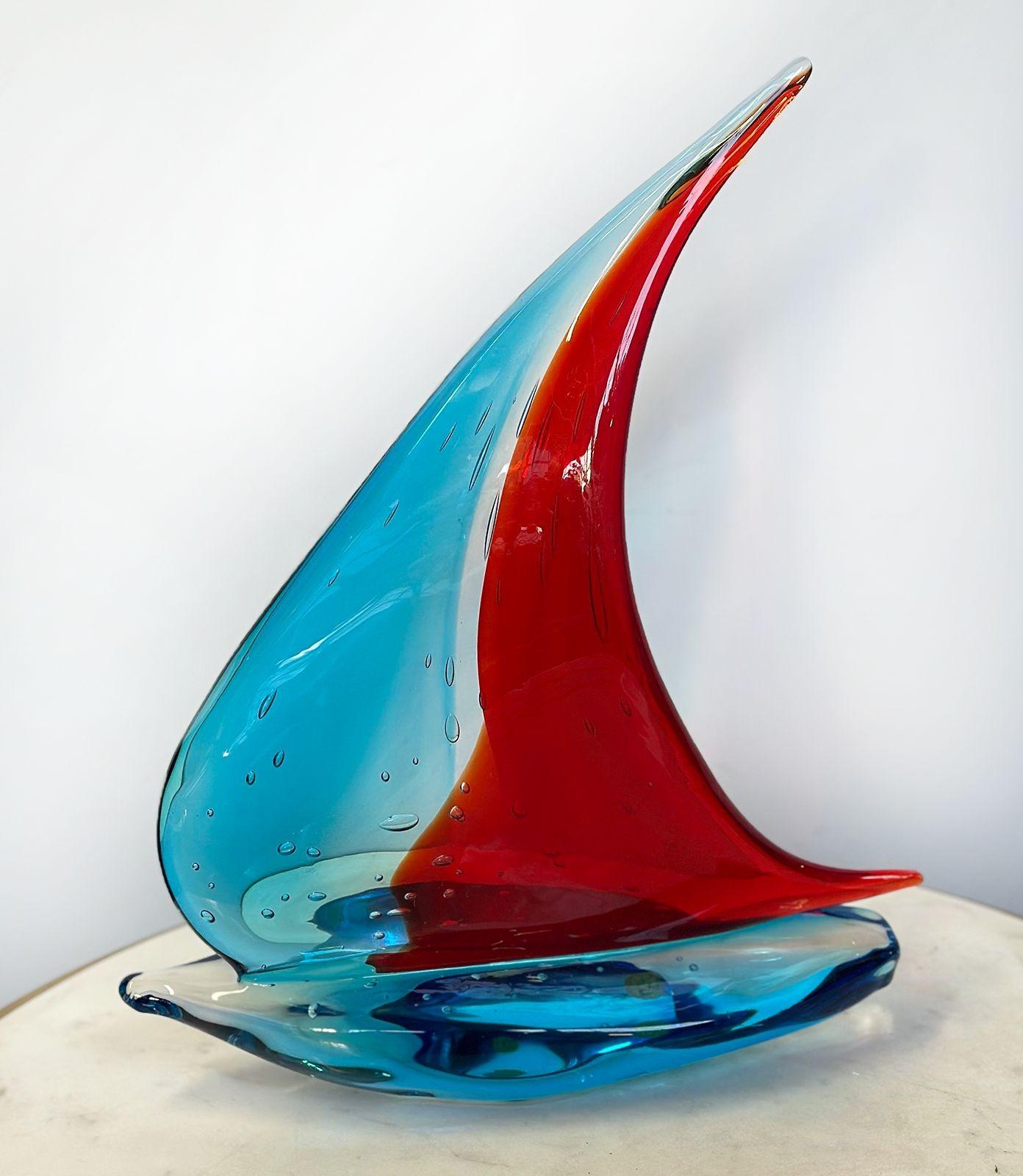 Vintage Italian handblown Murano glass sailboat sculpture with Vetro Artistico®Murano mark sticker and signed Sergio Costantini. This fantastic collectible sculpture stands out for its bright red and blue tones, as well as its unique abstract