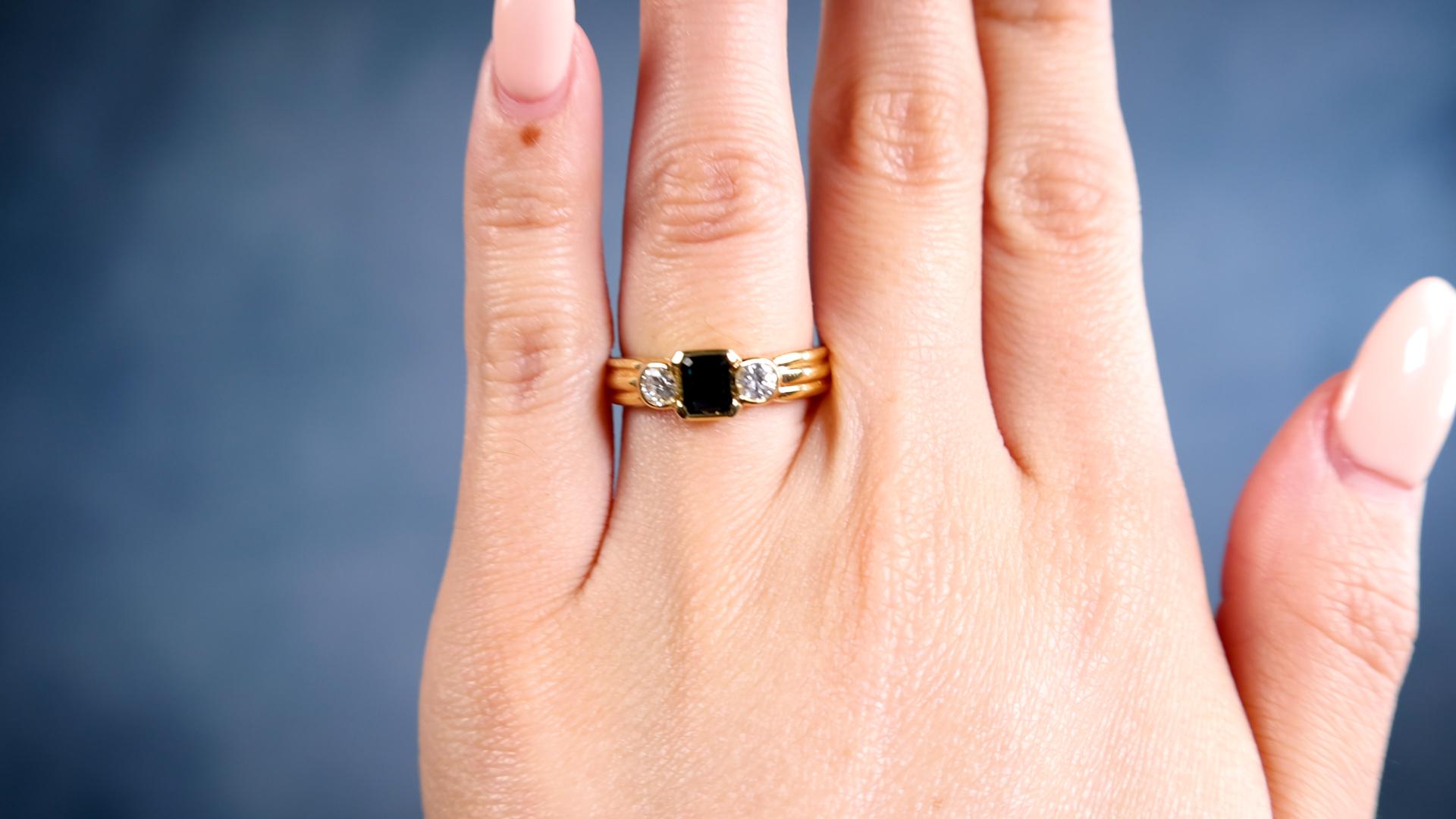 One Vintage Italian Sapphire Diamond 18k Yellow Gold Three Stone Ring. Featuring one octagonal step cut dark blue sapphire weighing approximately 0.50 carat. Accented by two round brilliant cut diamonds with a total weight of approximately 0.40