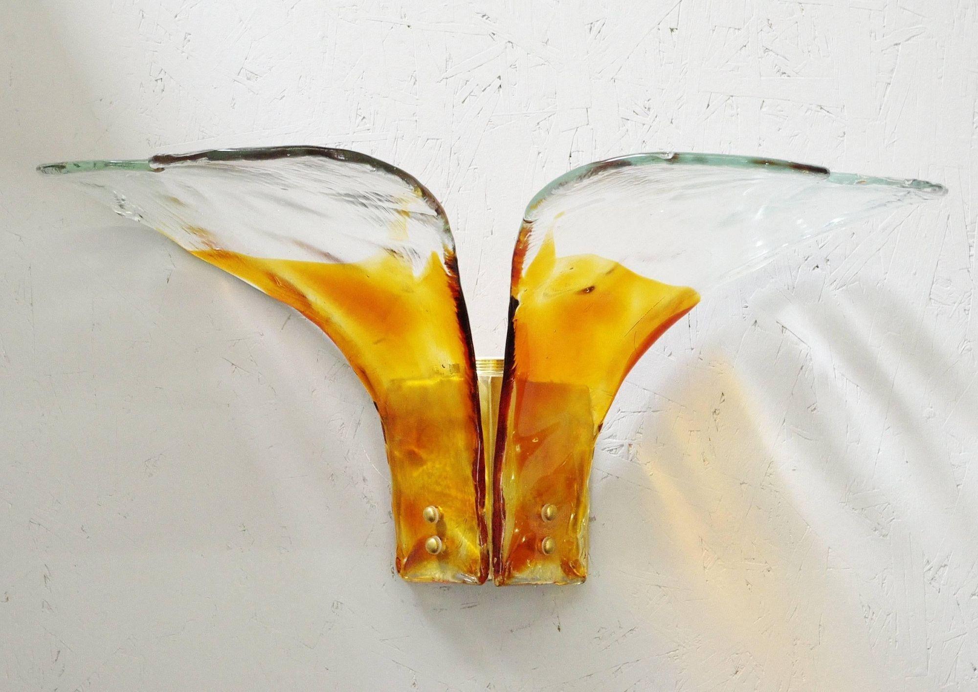 Vintage Italian sconces with hand blown amber and clear Murano glasses mounted on brass frames / Designed by Carlo Nason, circa 1960s / made in Italy 1 light / E26 or E27 type / max 40W.
Measures: height: 15 inches / width: 26 inches / depth: 13