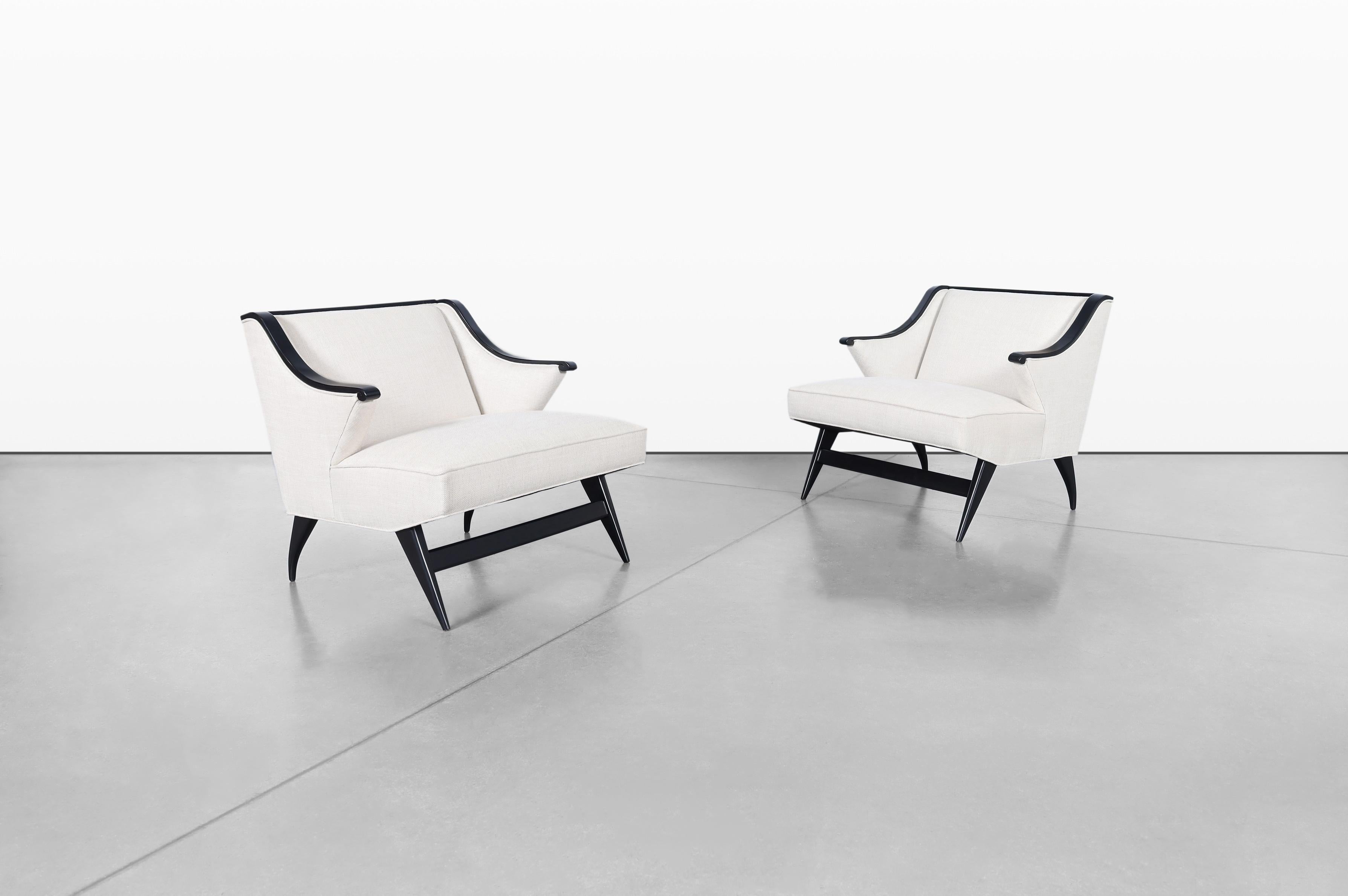 Introducing a stunning pair of vintage lounge chairs, expertly designed in Italy during the 1950s. These chairs are true examples of Italian craftsmanship, echoing the design language of Gio Ponti and featuring a sculptural design that captivates