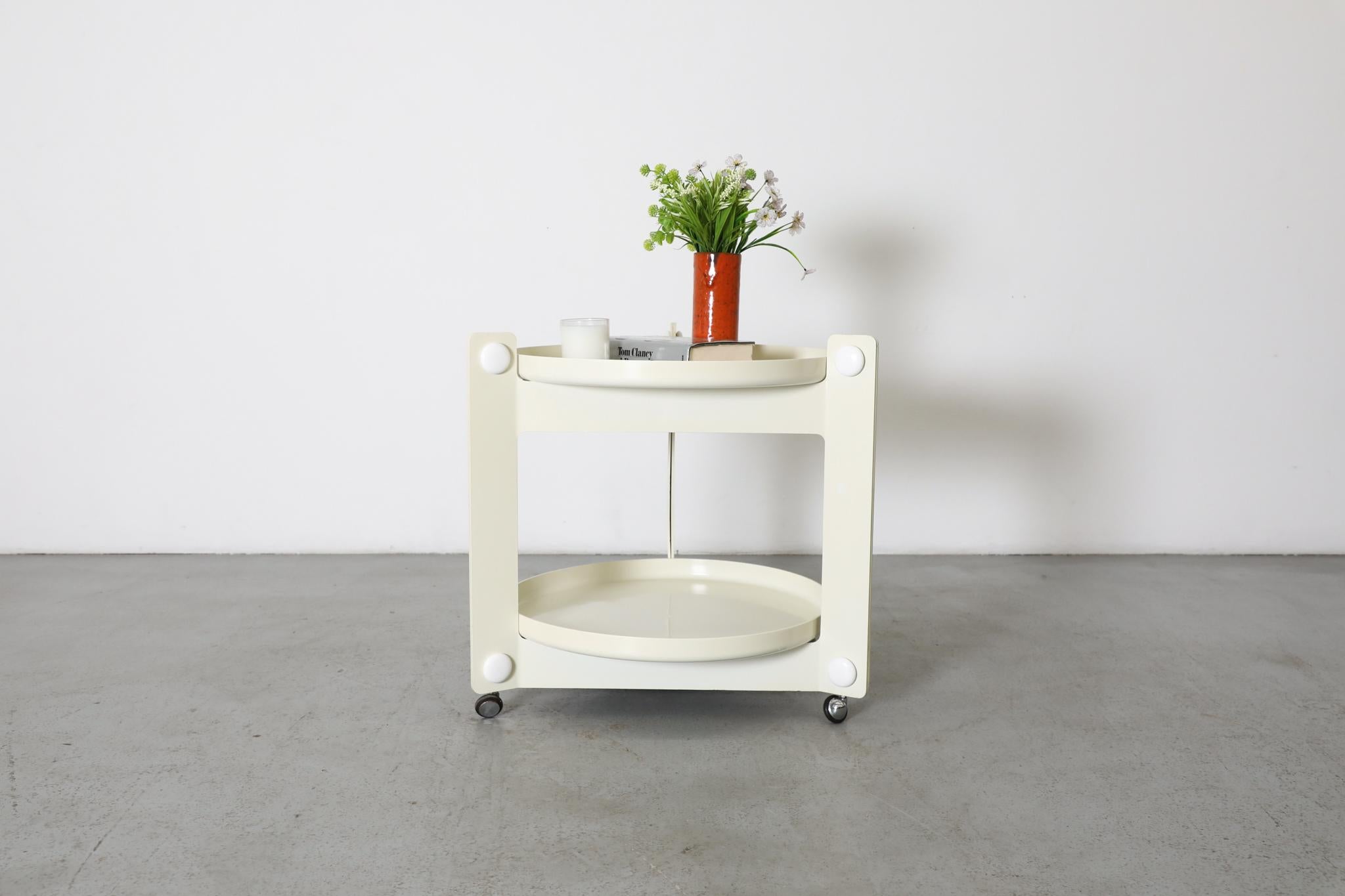 Space Age 1980's rolling cart with removable serving trays by Luigi Massoni for Guzzini. Off white acrylic trays with triangular base and chrome wheels. A sleek, MOD rolling cart with white accents. In original condition with some wear consistent