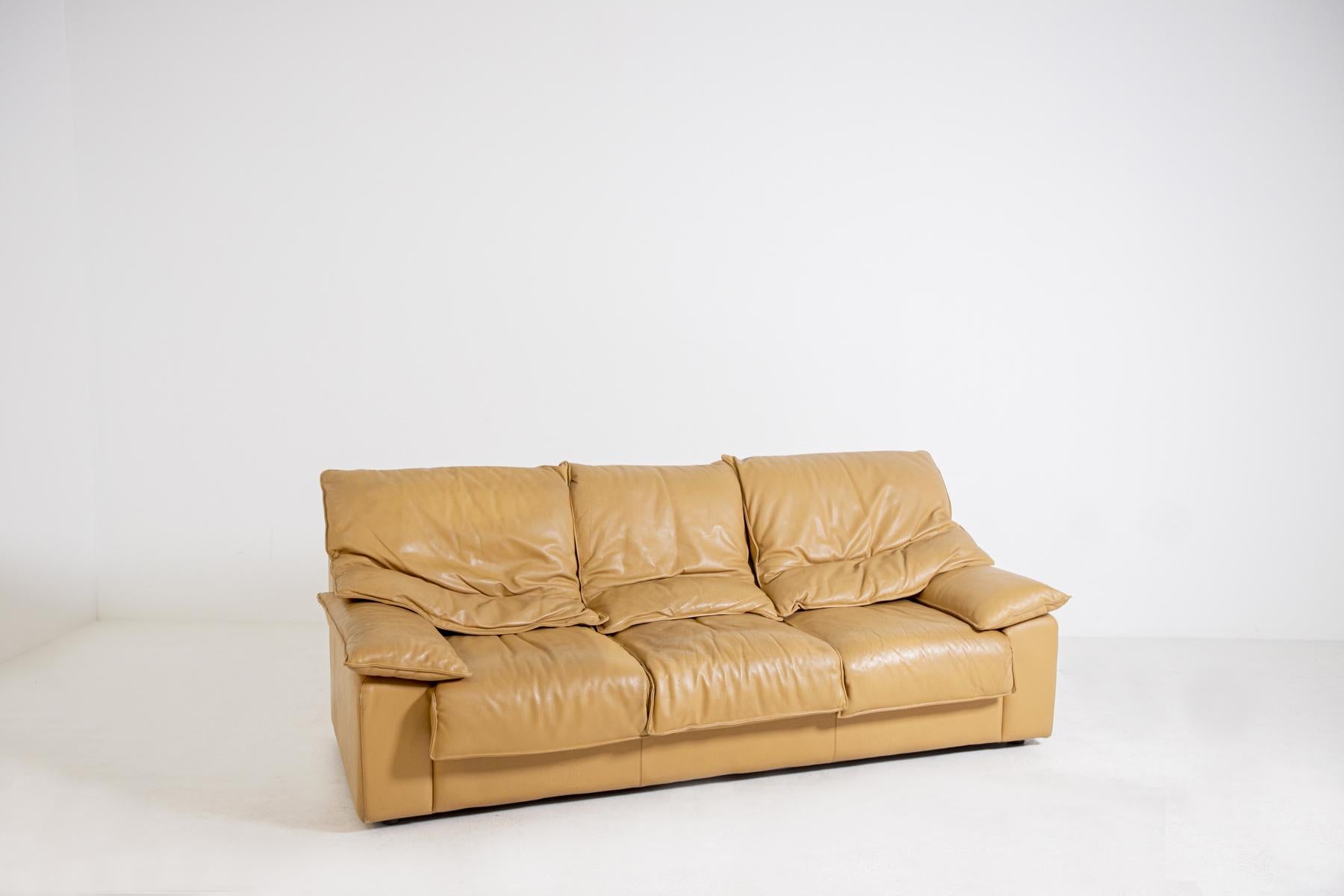 Italian-made three-seat sofa from the 1970s. The sofa is made of camel colored leather. The peculiarity of the sofa is in its double layer leather cushions.
Through the various layers of cushions the seat is received in a soft comfort. The sofa is