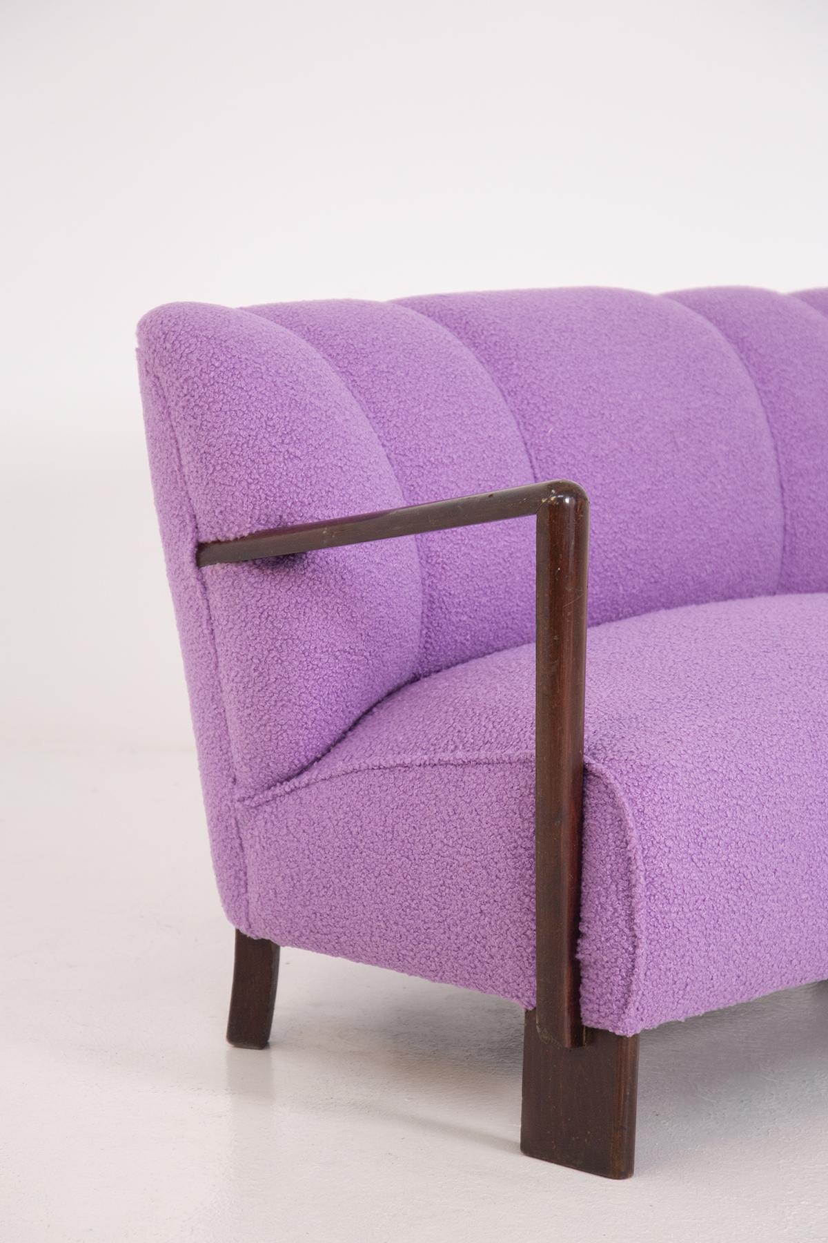 Comfortable two-seater Italian sofa from the 1950s. The sofa has been recently restored. The fabric has also been reupholstered in a warm and soft purple bouclé fabric. Italian Manifacture.
The sofa given its small size can be classified as a