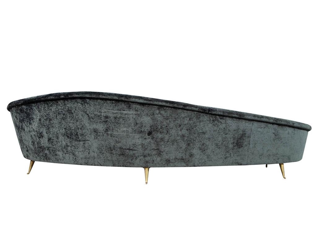Vintage Italian sofa in the manner of Federico Munari. Featuring a graceful crescent shape with sprouting brass legs. Recently re-upholstered in a grey velvet. Iconic Italian Mid-Century Modern design.