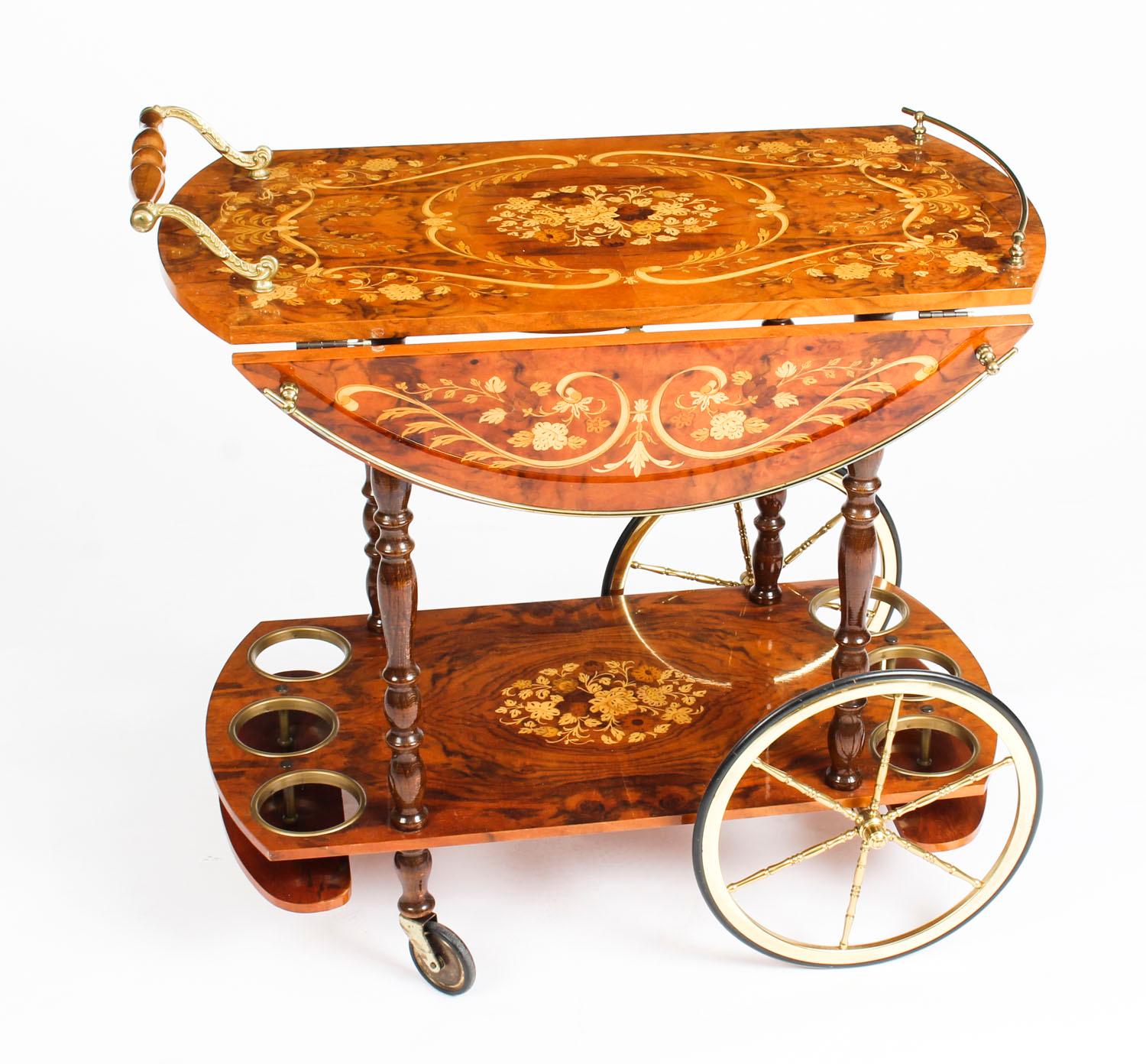 This is a very entertaining vintage midcentury Italian Sorrento drinks trolley.

The trolley is very decorative, with profuse floral marquetry decoration, galleried ormolu borders, and handles.

It can be used for serving drinks or purely for