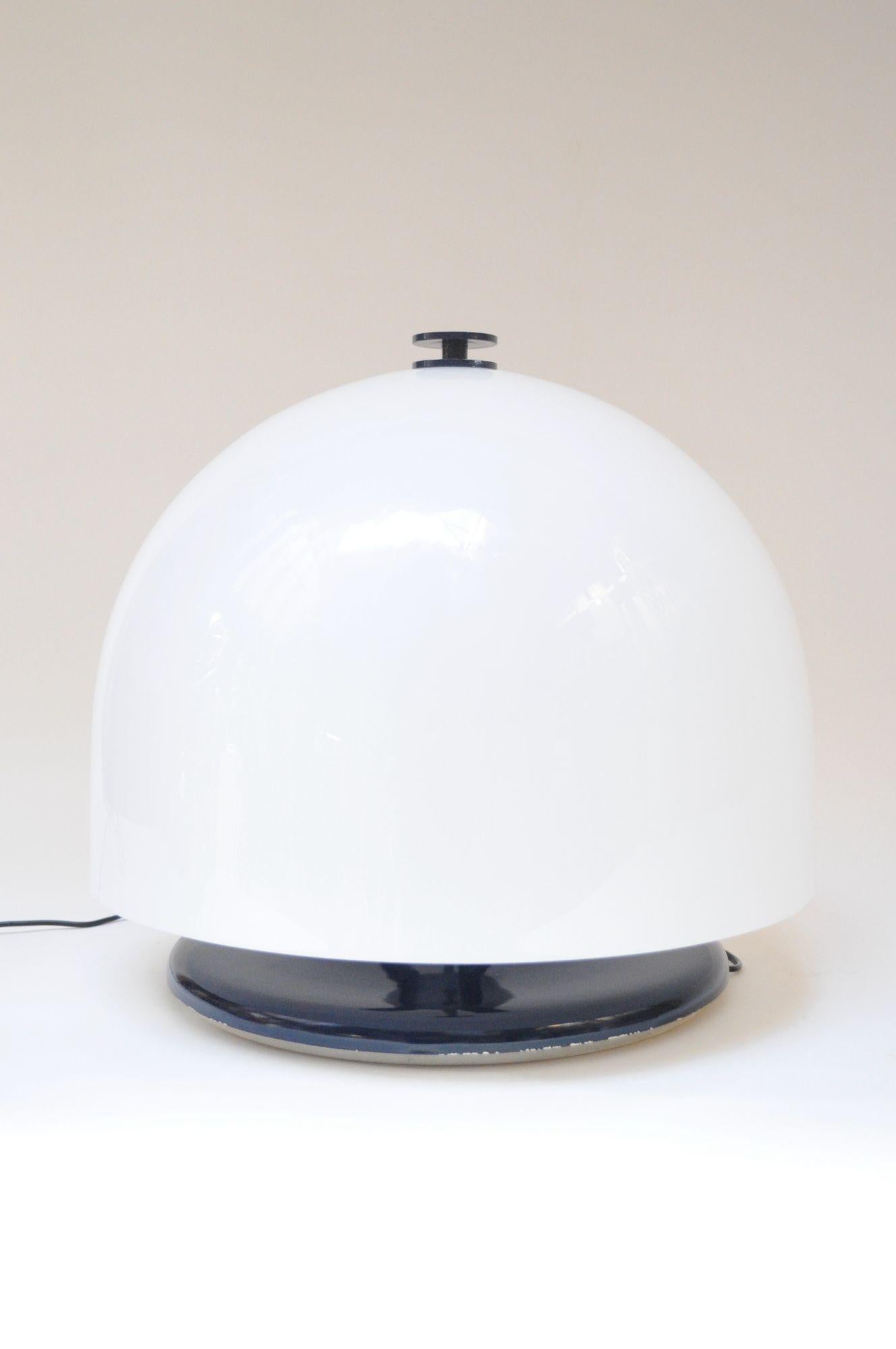 Space age/mushroom-form table lamp composed of an oversized, dome shade in white acrylic supported by a metal stem retaining the original navy enamel to the top finial and circular base (ca. 1970s, Italy). Three socket construction offering a