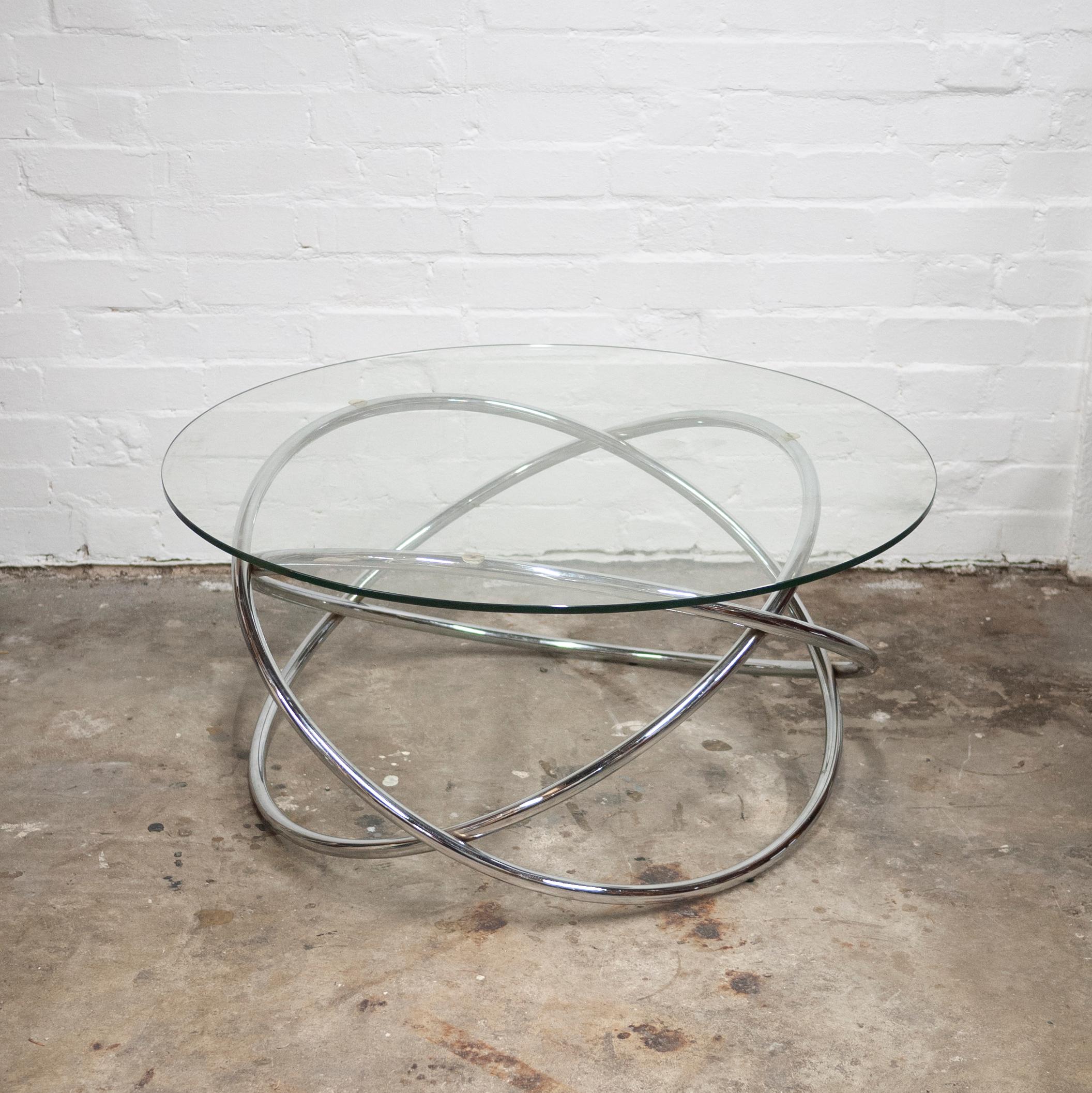 A glass and tubular metal coffee table with a spiral pedestal base in a Space Age style.

Designer - Unknown

Design Period - 1970 to 1979

Style - Vintage, Space Age

Detailed Condition - Good with minimal defects.

Restoration and Damage