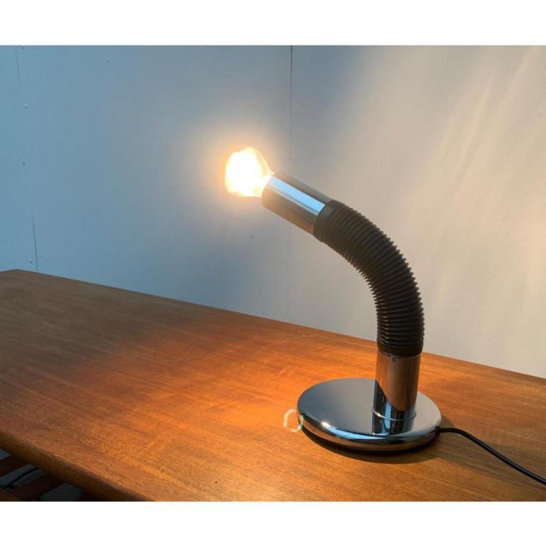 Lampes de table Space AGE de Targetti Sankey en chrome.

La tête du luminaire est mobile grâce à la partie centrale flexible du luminaire. Au bout, une simple assise E27. La tête du luminaire est donc formée par l'ampoule correspondante. Le