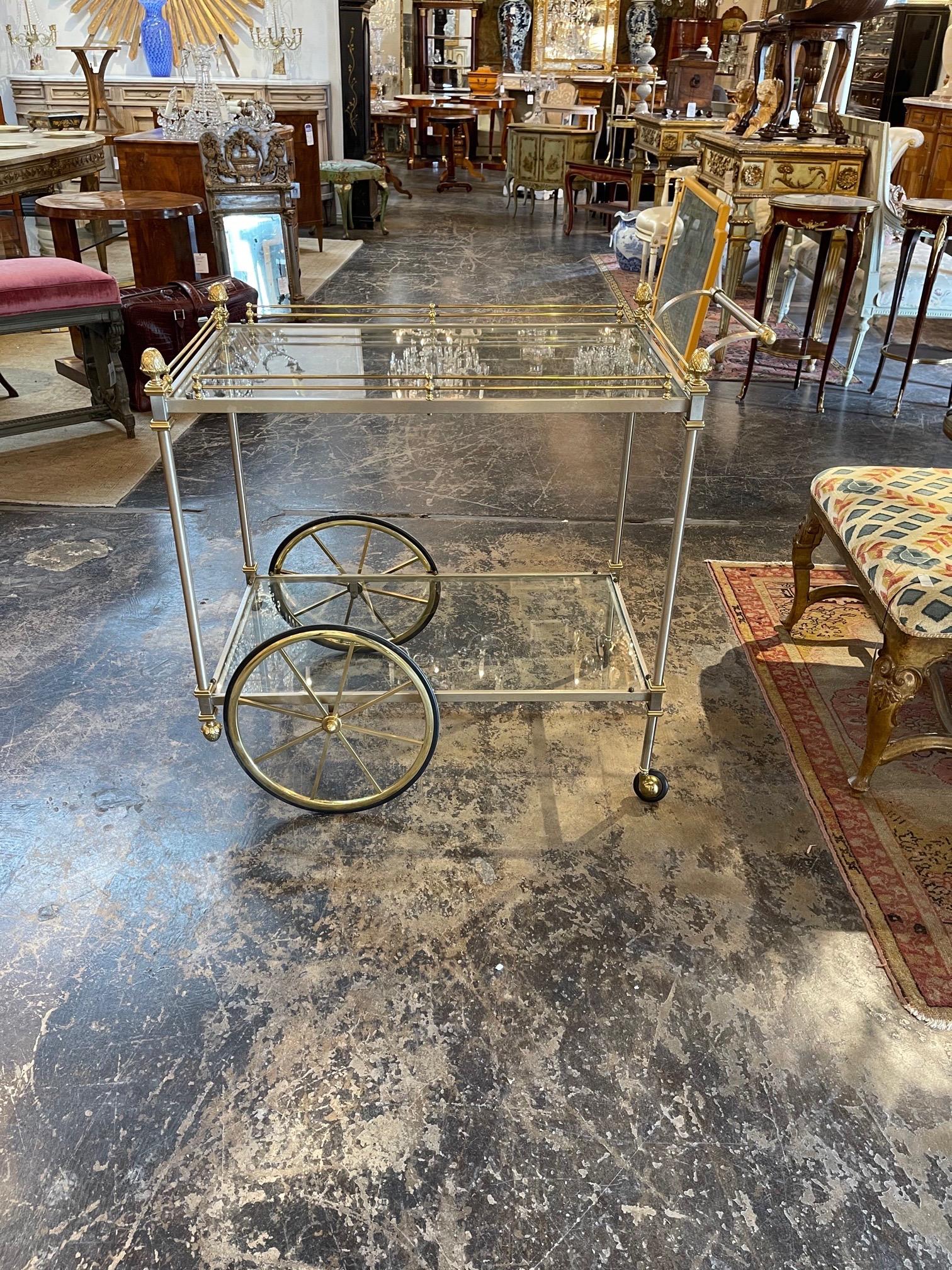 Decorative vintage Italian steel and brass bar cart, possibly Jansen. Very pretty details including brass finials on the legs. A fabulous addition!