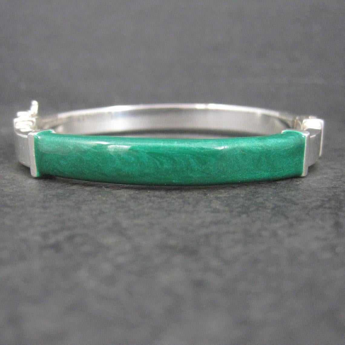 This beautiful vintage bangle bracelet is sterling silver with green enamel.

Measurements: 8mm wide, Inner circumference of 7, inner diameter of 2 by 2 1/4 inches
Weight: 20.2 grams

Marks: 925, Italy

Condition: Perfect - possibly old new stock