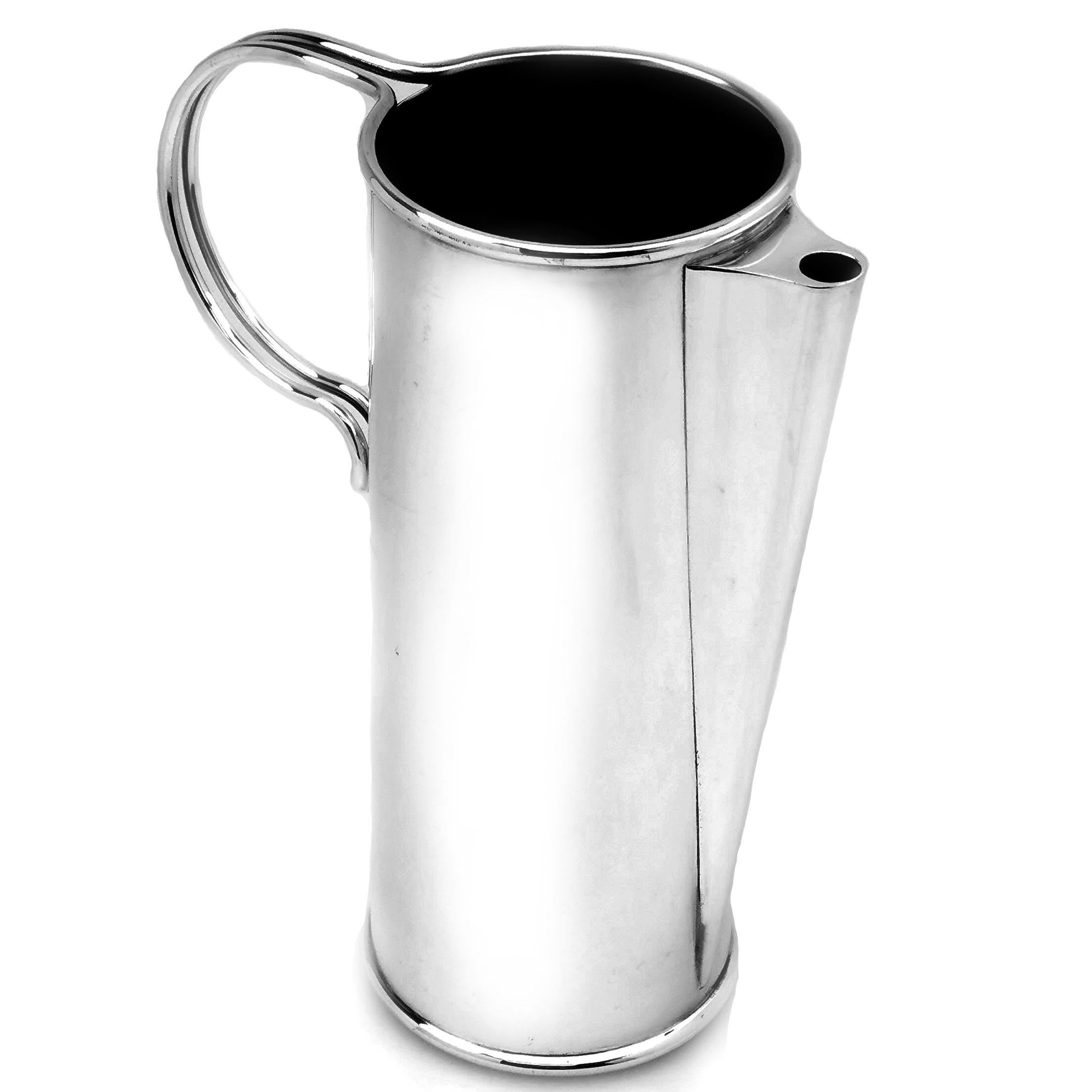 A stylish Vintage Italian Jug with an understated elegant straight sided design displaying the luster of plain polished silver. The Jug has subtle spout which has a straight geometric line from the base and a understated handle and is a wonderful