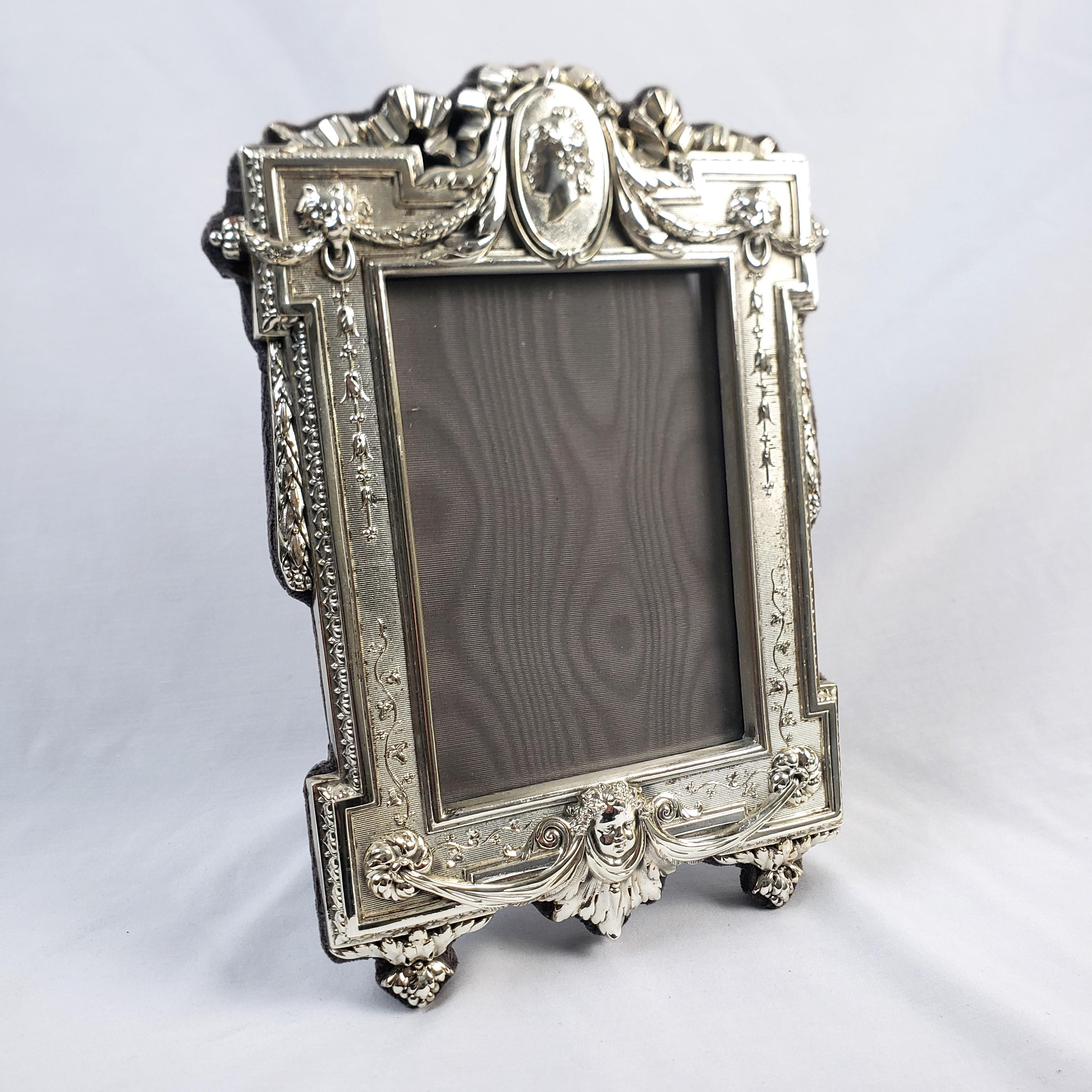 This vintage picture or mirror frame is signed by an unknown maker and presumed to have originated from Italy and date to approximately 1970 and done in a Gothic Revival style. The front of the frame is composed of sterling silver with ornate