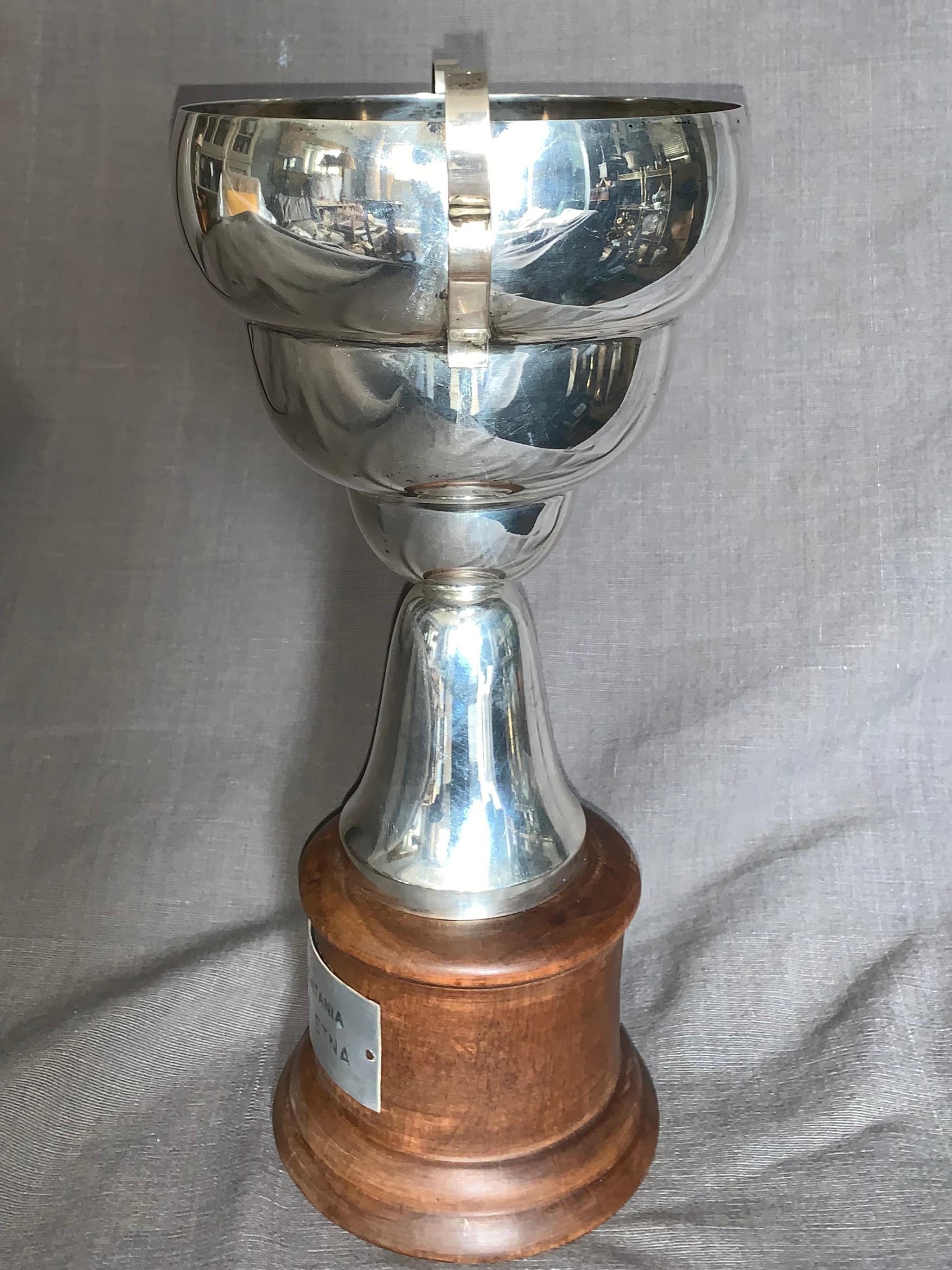 Italian silver racing trophy. Midcentury sterling silver Sicilian motorcycle racing trophy in the Bibendum style on a pale mahogany base with inscription “Moto Club Catania VI Catania Etna”, Italy, late 1960s
Dimensions: 12