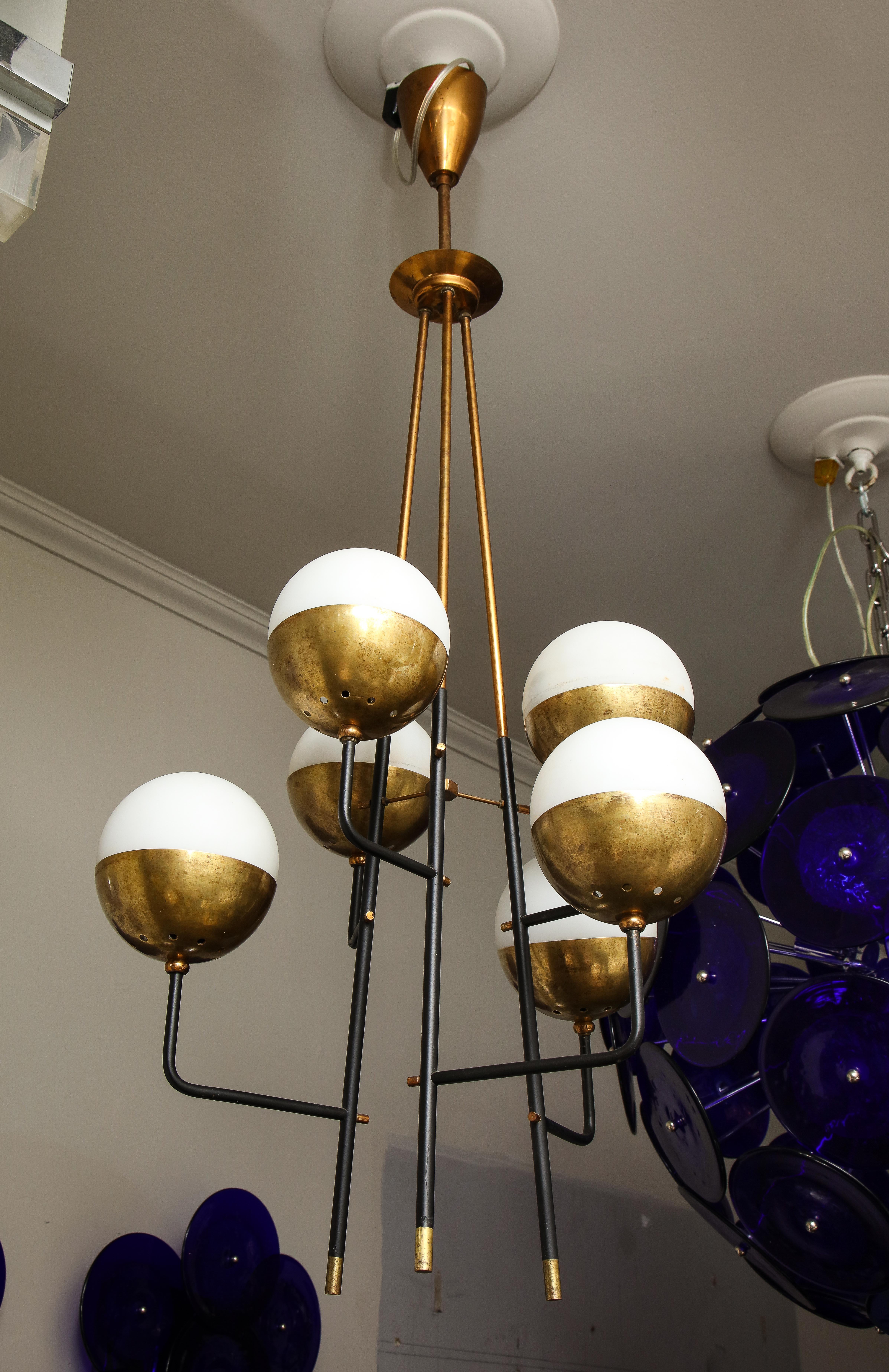 1950s vintage Italian Stillovo chandelier with black lacquered metal structure, brass shade holder, and opaline glass shades.