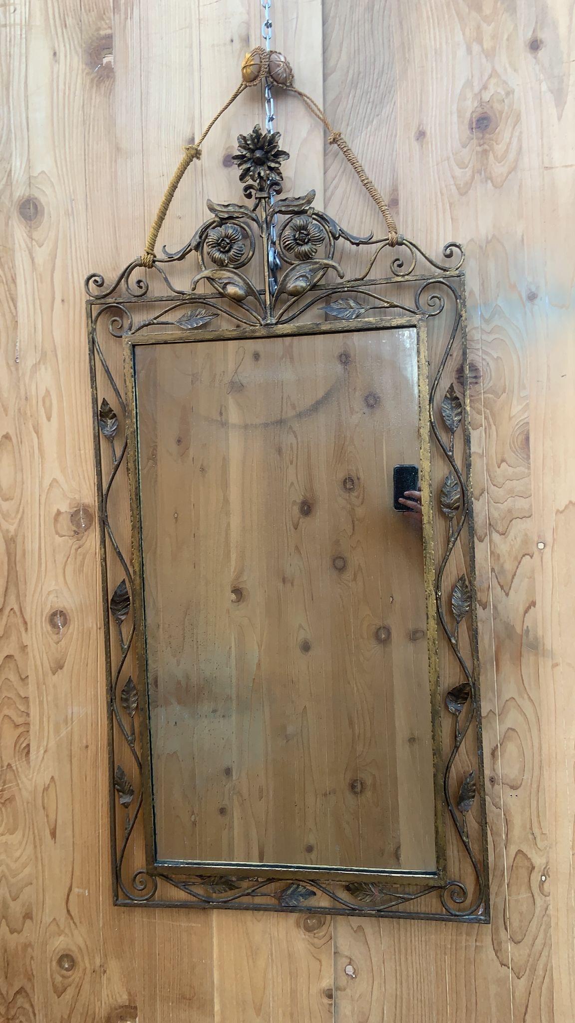 Vintage Italian Style Forged and Gilded Floral Wall Mirror 

This is a beautiful rectangular Italian mirror with floral and leaf design. It would be a statement in a foyer, bathroom bedroom or living room. 

Circa 1930

Dimensions:
H 50”
W 25”
D 2”

