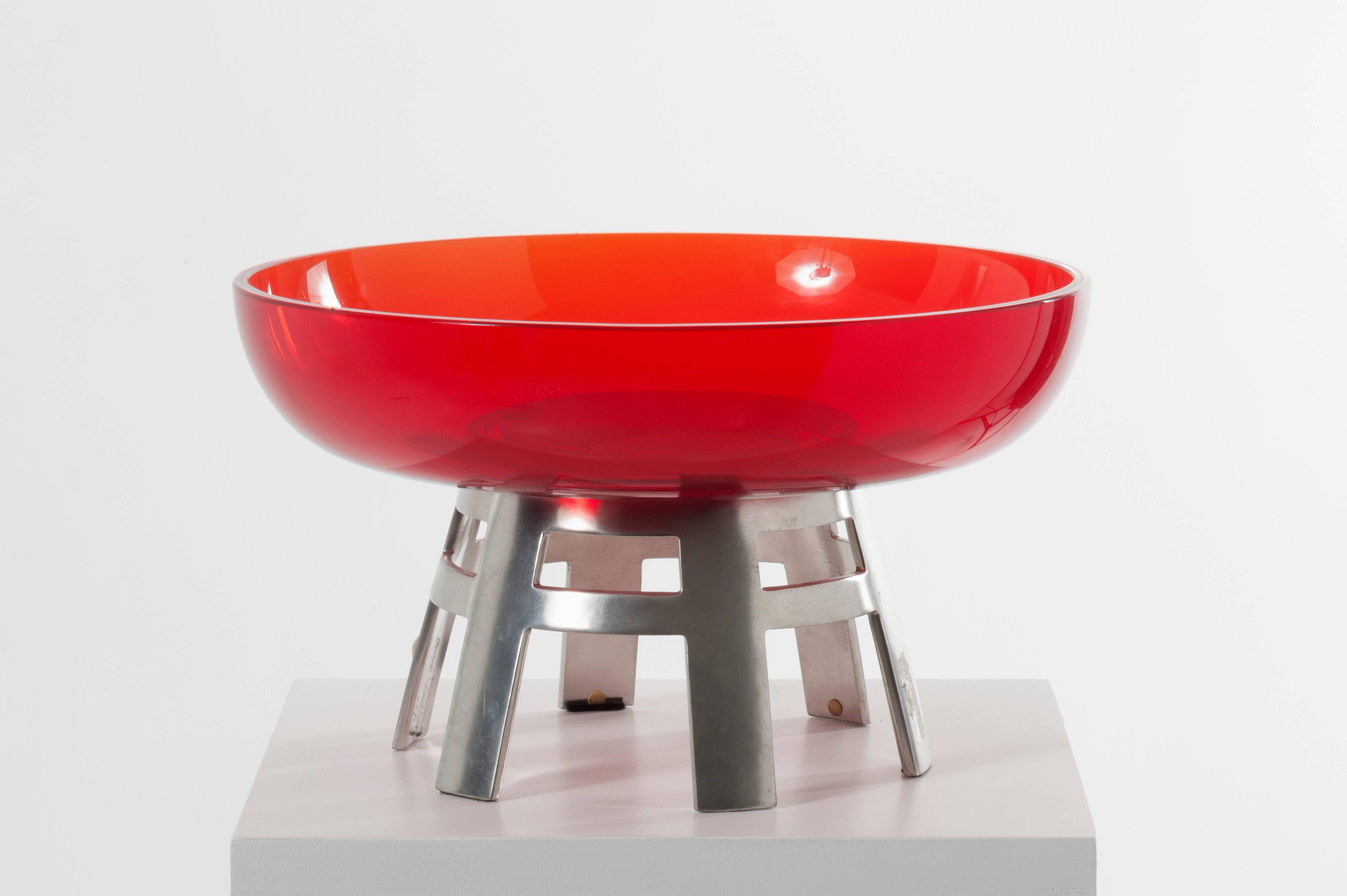 Vintage table centerpiece made of a perforated metal base raised on six feet and a red glass bowl, signed No. 34/99
by Ettore Sottsass manufactured by Numa, Italy, circa 1980
Measures: 12.6 in plate diameter - 8.26 in total height
Diameter coupe