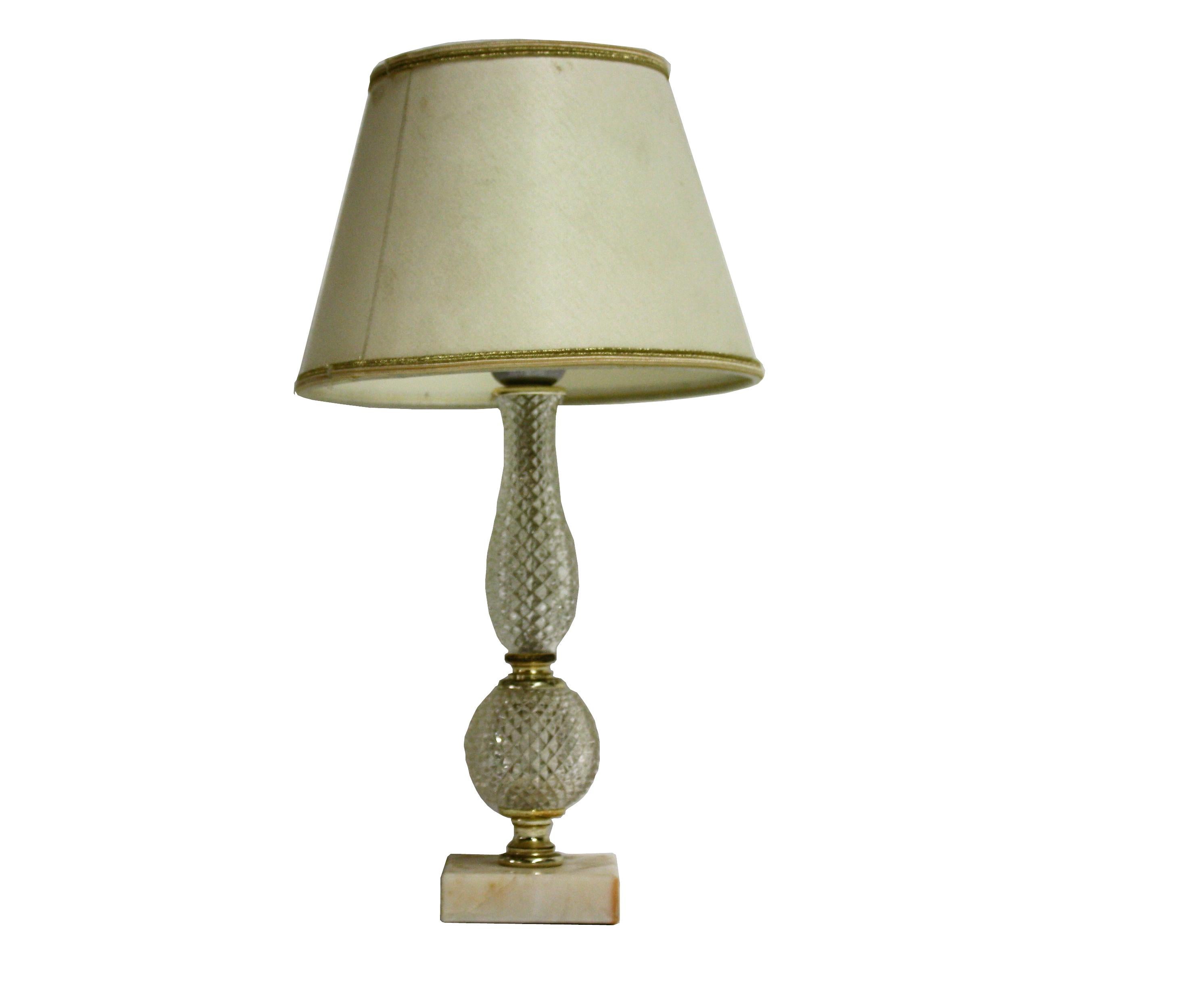 Charming table lamp made from a brass and crystal glass centrepiece mounted on a marble base.

The original fabric lamp shade with a golden finish is still in good condition.

Very classical yet charming table lamp.

Tested and ready for