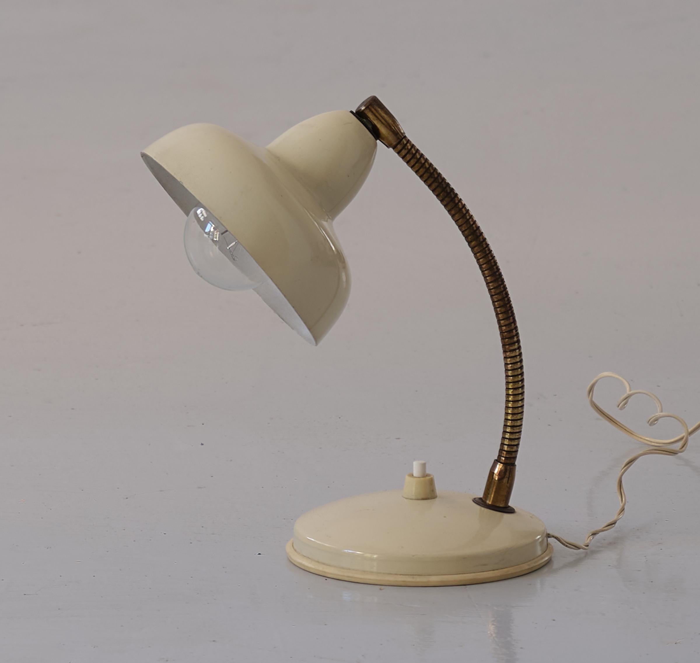 Small vintage table or bedside lamp, made of brass and cream-colored enamelled metal , Italy , 1950's .

This abat jour is in good vintage condition.
Original working wire with standard E14 bulbs. We can supply USA plug adapter if needed.