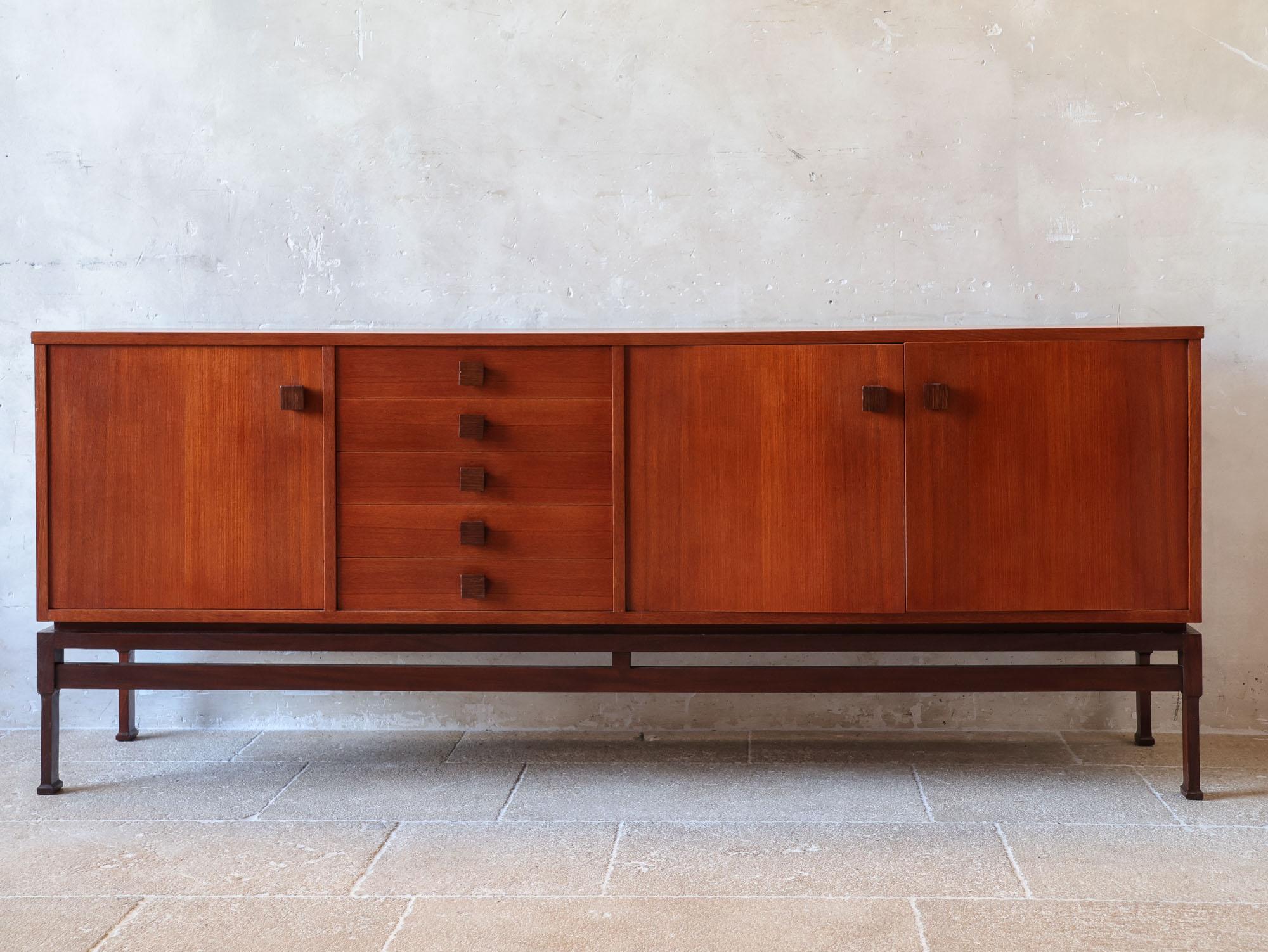 Vintage Italian teak sideboard in the style of Vittorio Dassi, dating from the 1970s. This retro cabinet features a minimalist design with three square doors and five drawers, all accented with square handles. The clean lines and elegant structure