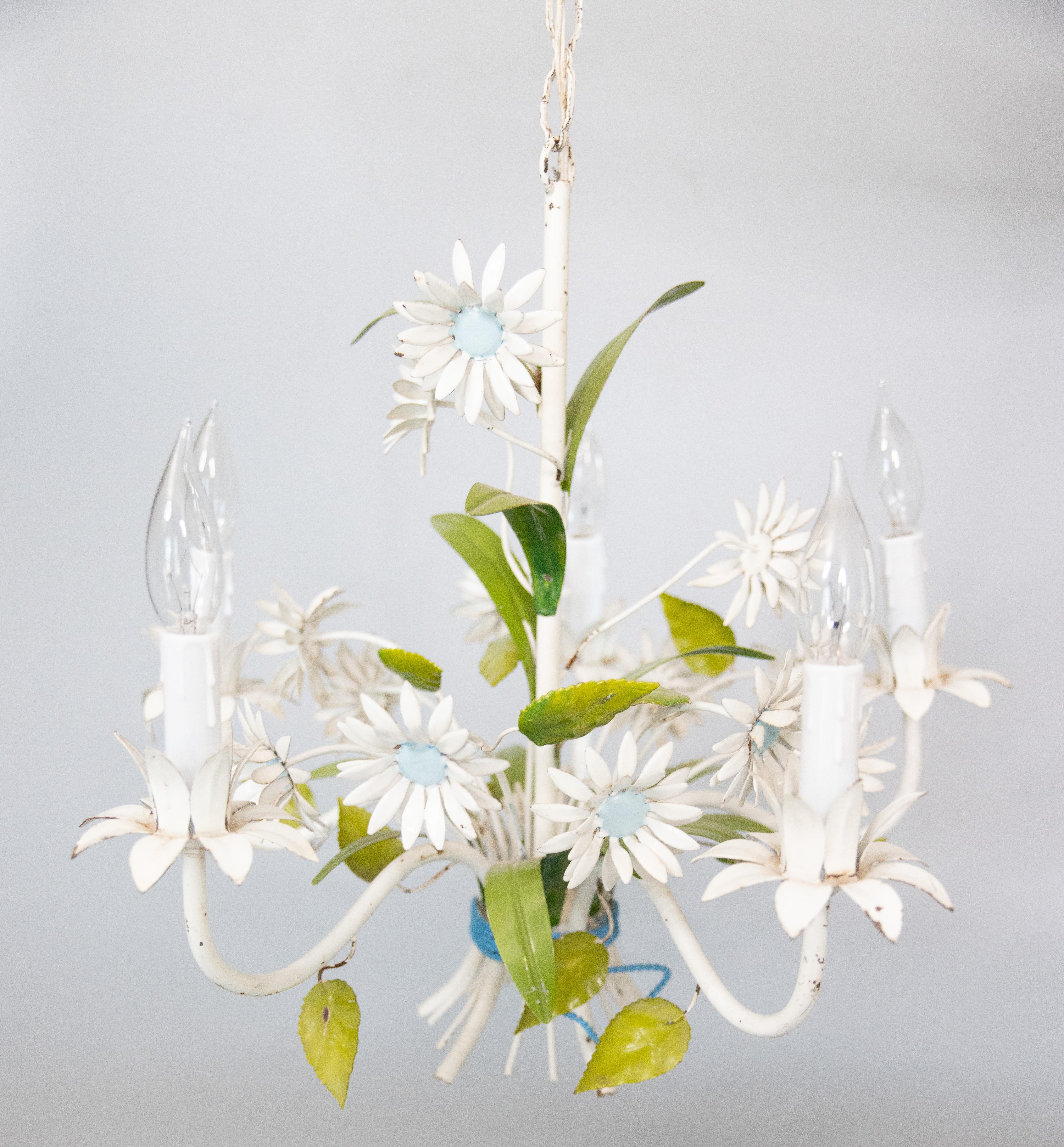 A lovely vintage Italian tole five-arm floral chandelier, circa 1950. This charming hand painted chandelier has scrolling green leaves and beautiful blue-eyed daisies. It's in excellent working condition and comes with the original white ceiling
