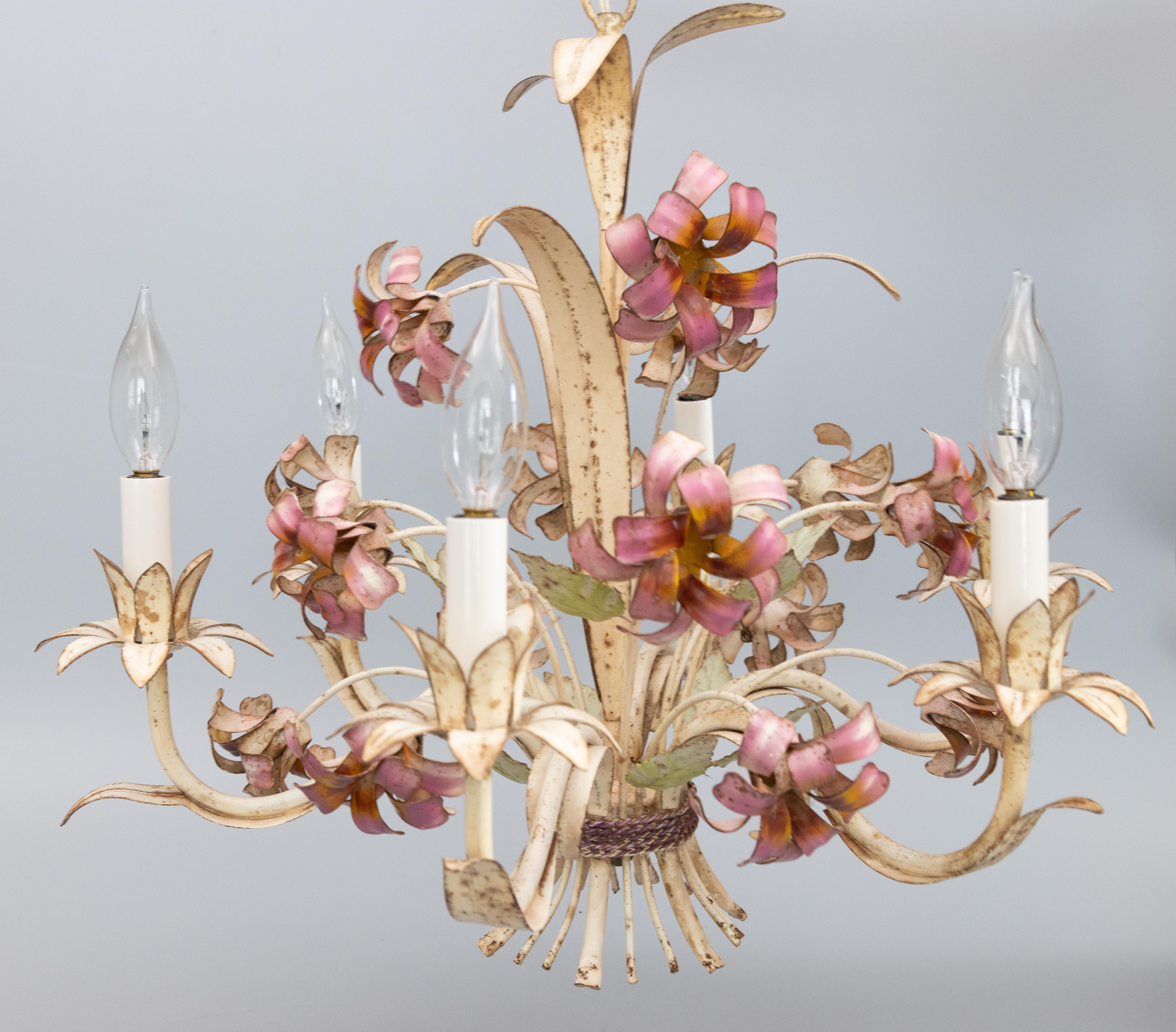 Mid-20th century Italian tole floral six-arm chandelier. This charming hand painted chandelier has scrolling green leaves and lovely pink flowers. It's in excellent working condition and comes with the original ceiling plate and 3 inches of chain.