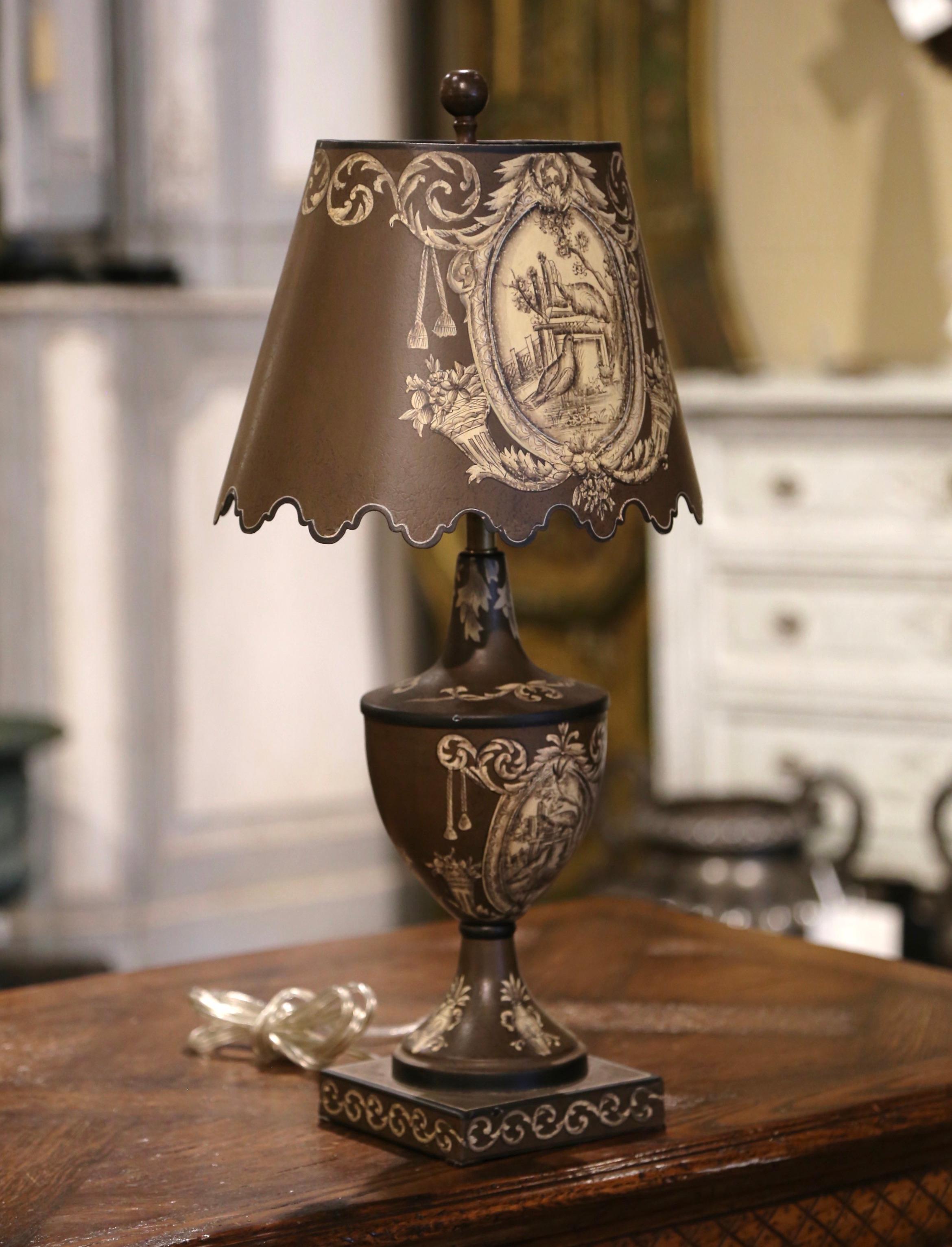Add an air of drama and elegance to your home with this chocolate-colored tole antique table lamp. Crafted in Italy circa 2000, the delicate brown light-fixture with yellow-gold details stands on a square base decorated with painted vines; the body