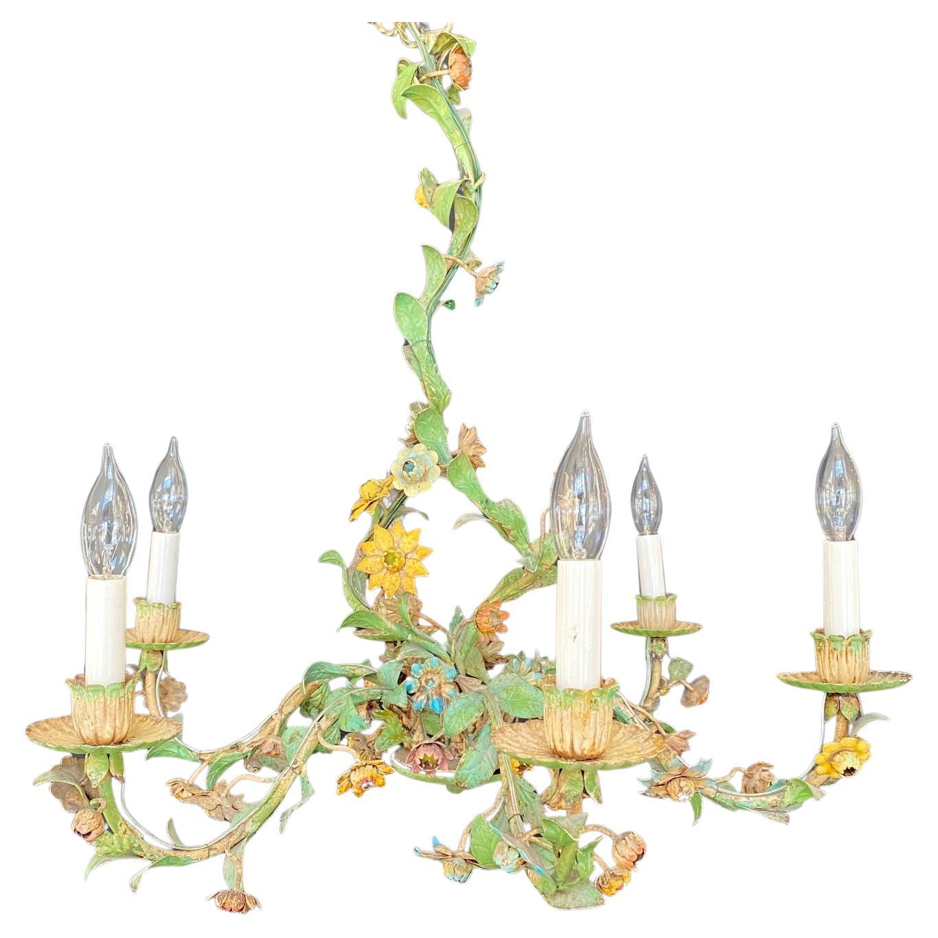 Lovely Hollywood Regency painted tole floral chandelier with leaves and vines made in Italy. Mid-20th century Italian tole floral six-arm chandelier. This charming hand painted chandelier has scrolling green leaves and lovely pink flowers. 
#6279

