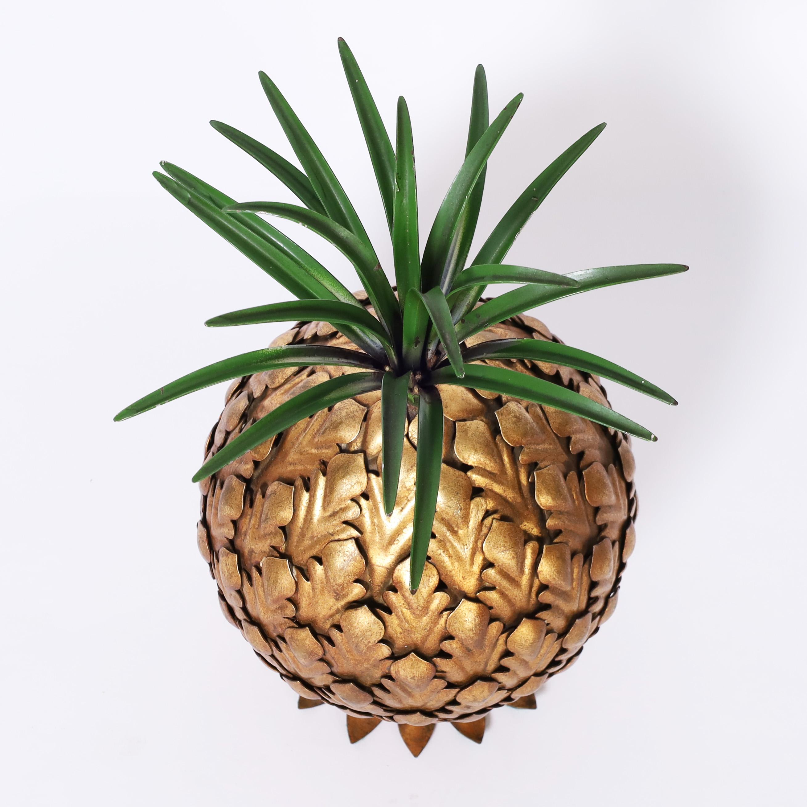 Standout mid century Italian tole sculpture or object of art crafted in metal with a painted green top over a stylized gilt pineapple. Stamped Italy on the bottom. 