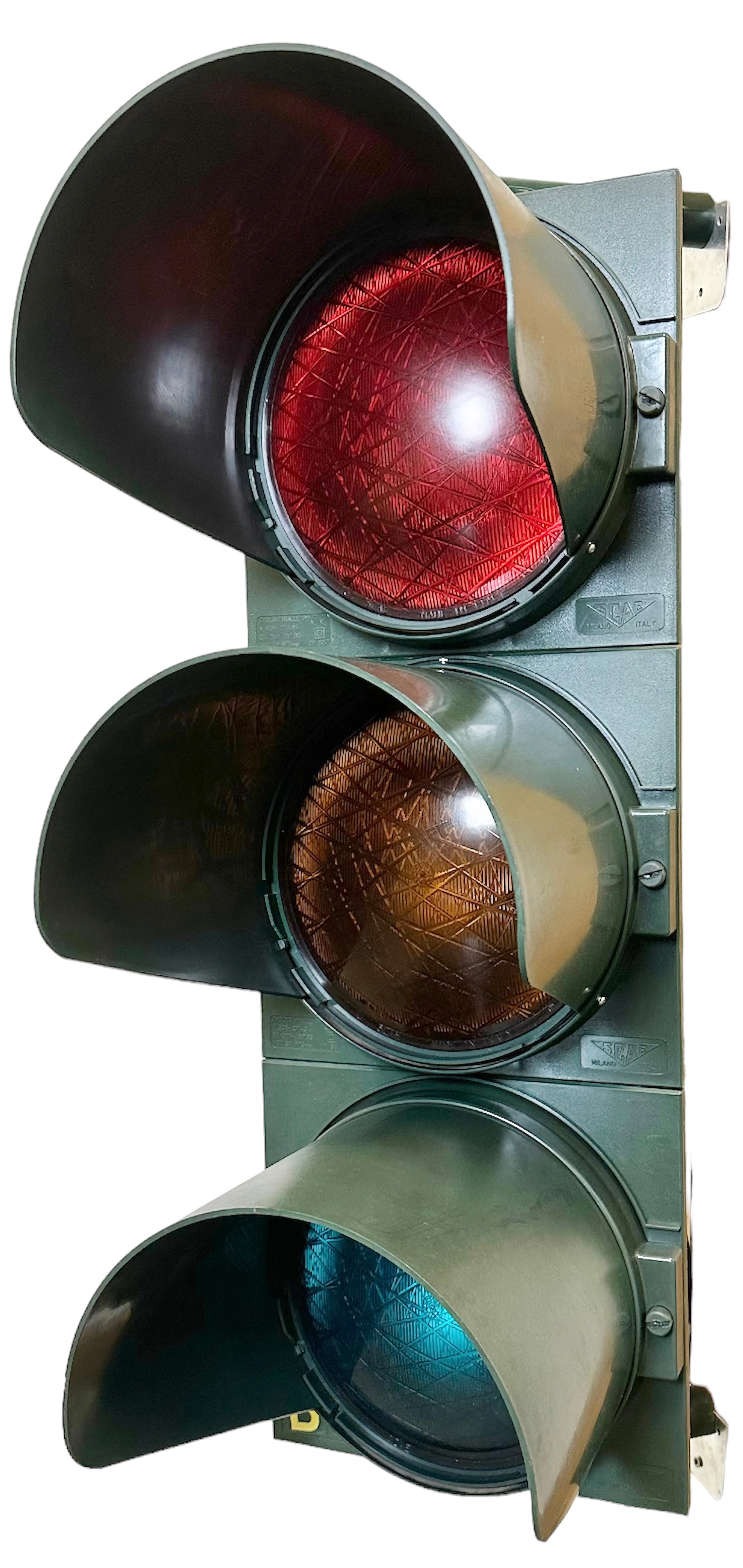 Vintage industrial italian traffic light made by SCAE Milano in Italy during the 1980s. It features green bakelite body and color plastic glass covers. The sockets require standard E 27/ E 26 lightbulbs. Rewired to be lit as a lamp or decorative