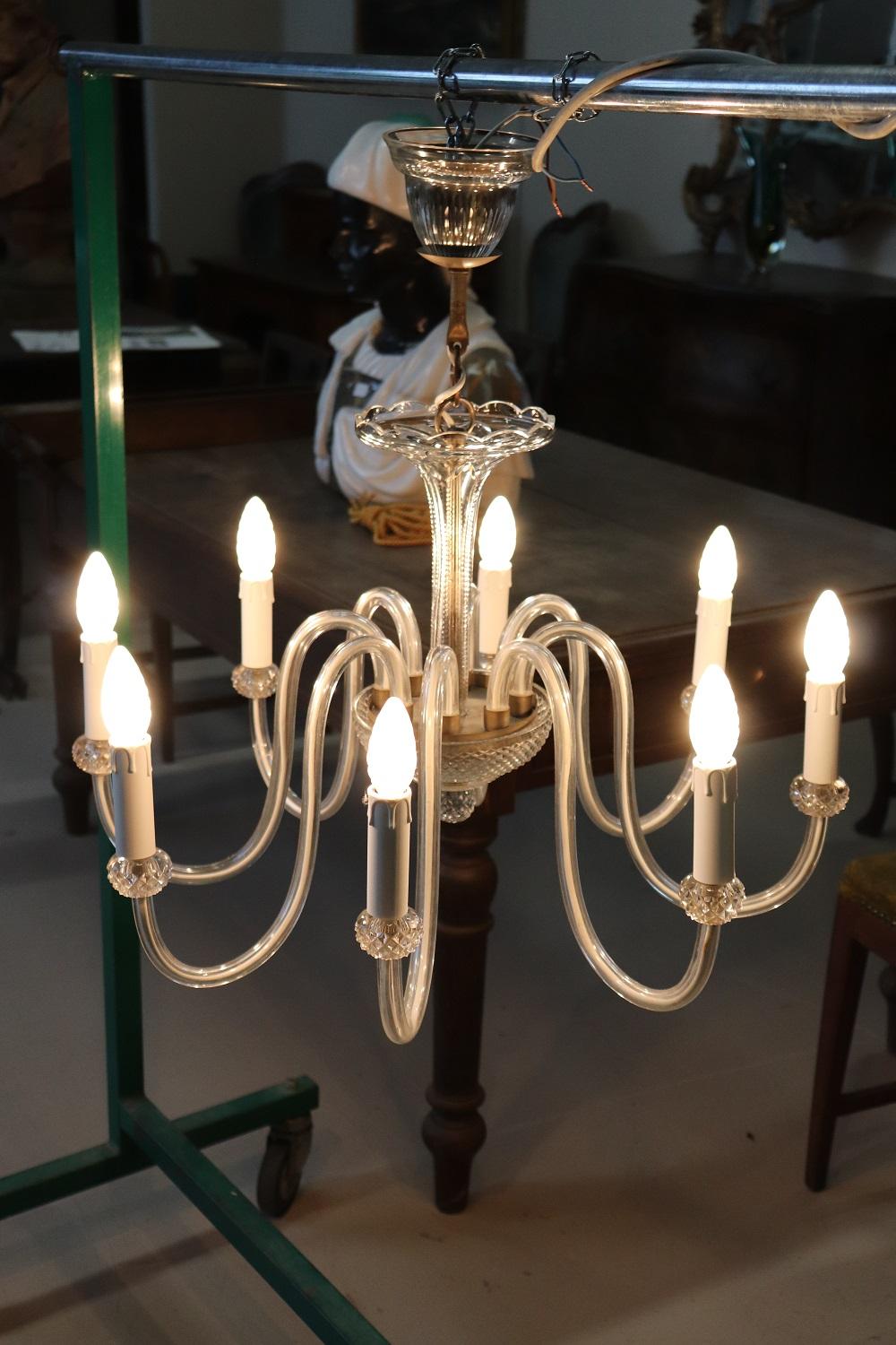 Beautiful and refined murano glass chandelier 1980s total eight lights. The chandelier is made with the classic artistic work of Murano glass in delicate and rare transparent glass. Fully functional.