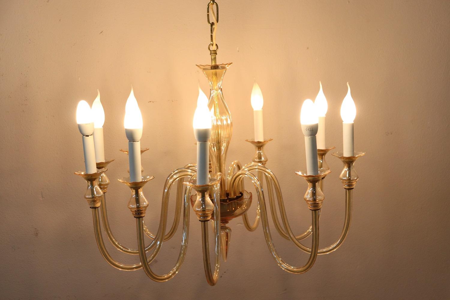 Beautiful and refined artistic glass chandelier of Murano 20th century, 1980s total ten lights. The chandelier is made with the classic artistic work of Murano glass in delicate and rare transparent yellow glass. Fully functional. The total height
