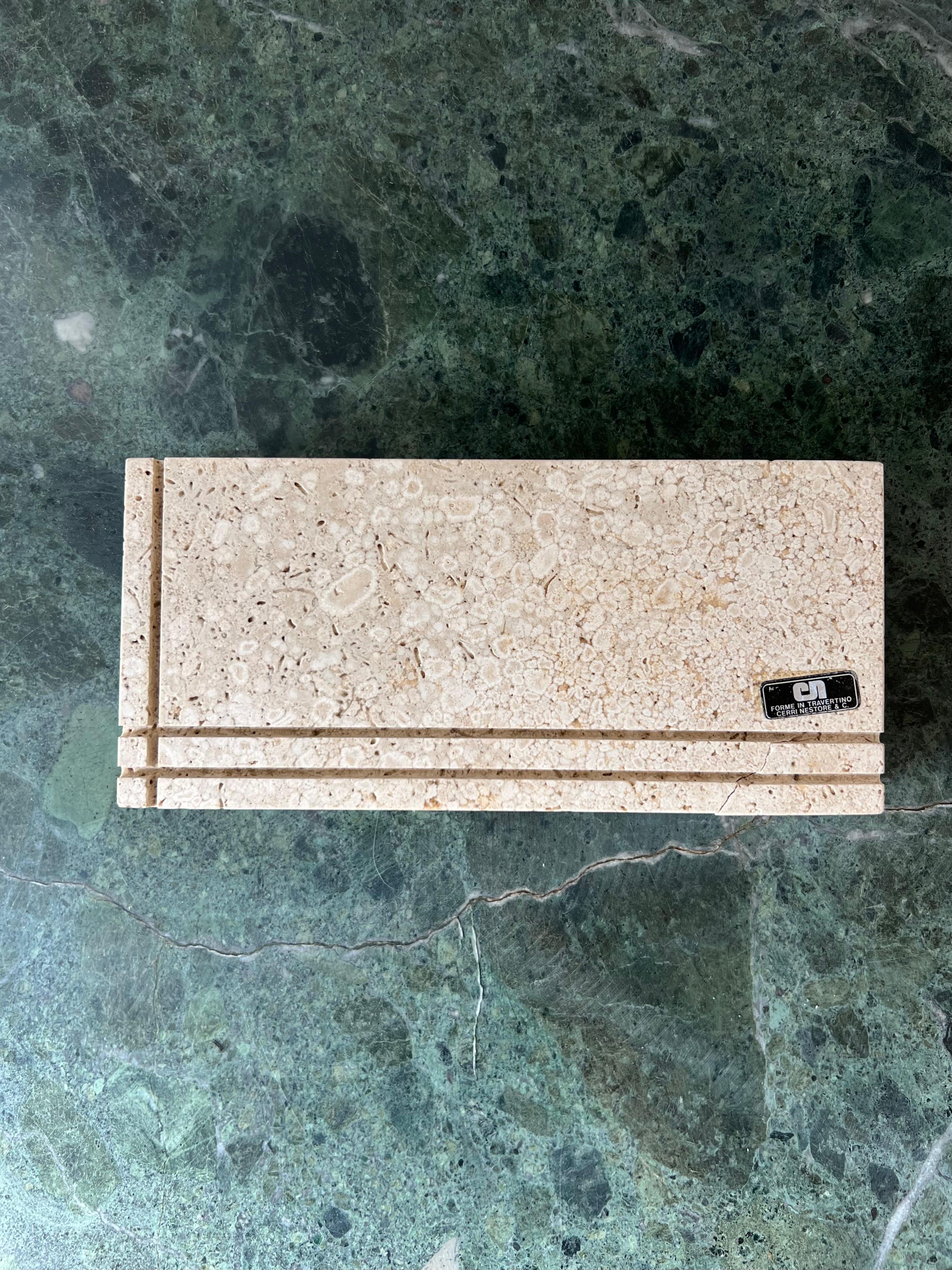 A vintage Italian travertine box by Cerri Nestore, 1970s. Unique geometric lines classic to Nestore accent the top. This item was hand-crafted in Italy so elements of the construction are visible. The travertine is raw, rather than polished or