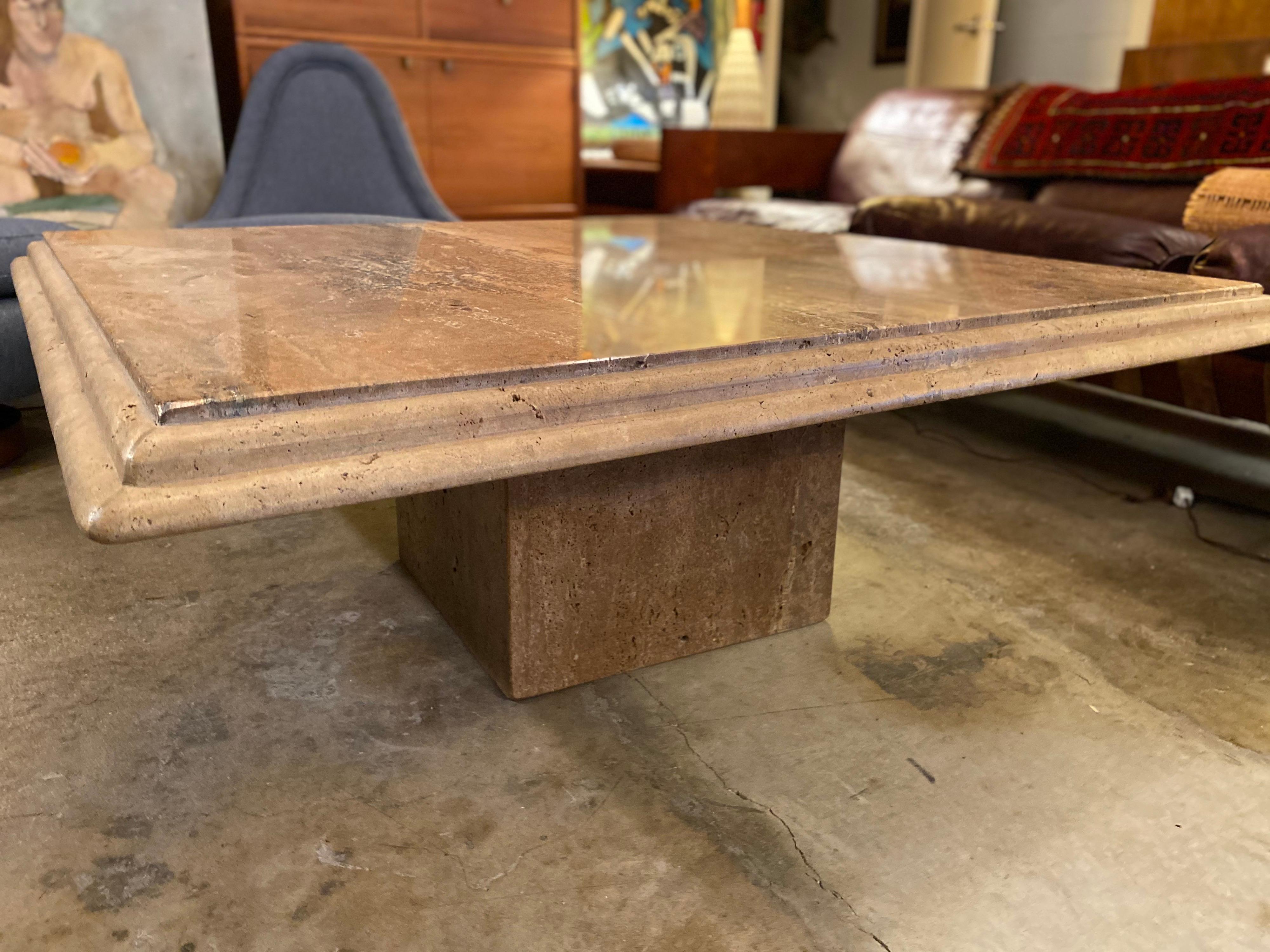 Mid-Century Modern Italian travertine coffee table with beveled edges on travertine detachable base, circa 1970s. This vintage coffee table is in good overall condition.