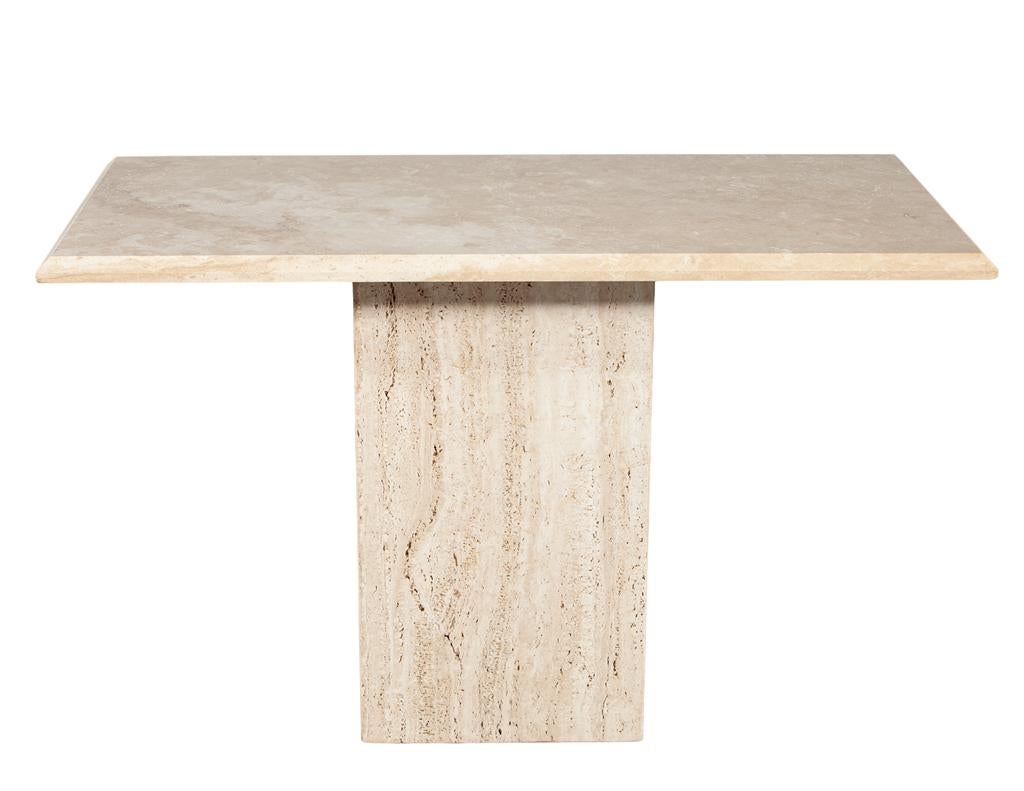 Add a touch of Italian modern design to your space with this beautiful travertine console table from the 1970s. Featuring a sleek tapered edge, this piece embodies mid-century sophistication. Crafted in Italy, the natural beauty of the travertine