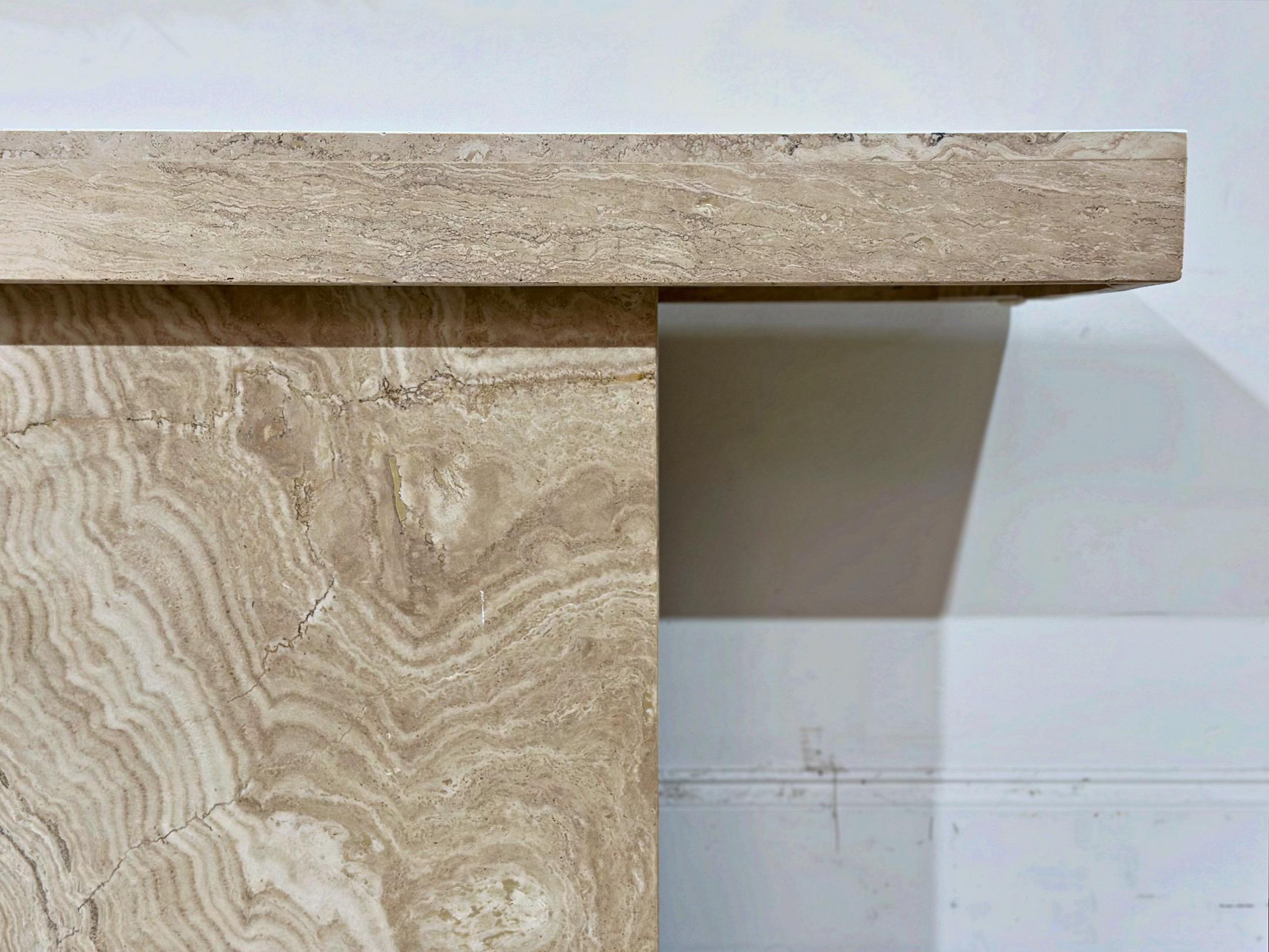 Minimalist post modern beige Roche Bobois style travertine marble console table. Gorgeous undulating grain pattern on both the top and base. This console table would look great in an entryway or accenting a beautiful sculpture. Table comes in two