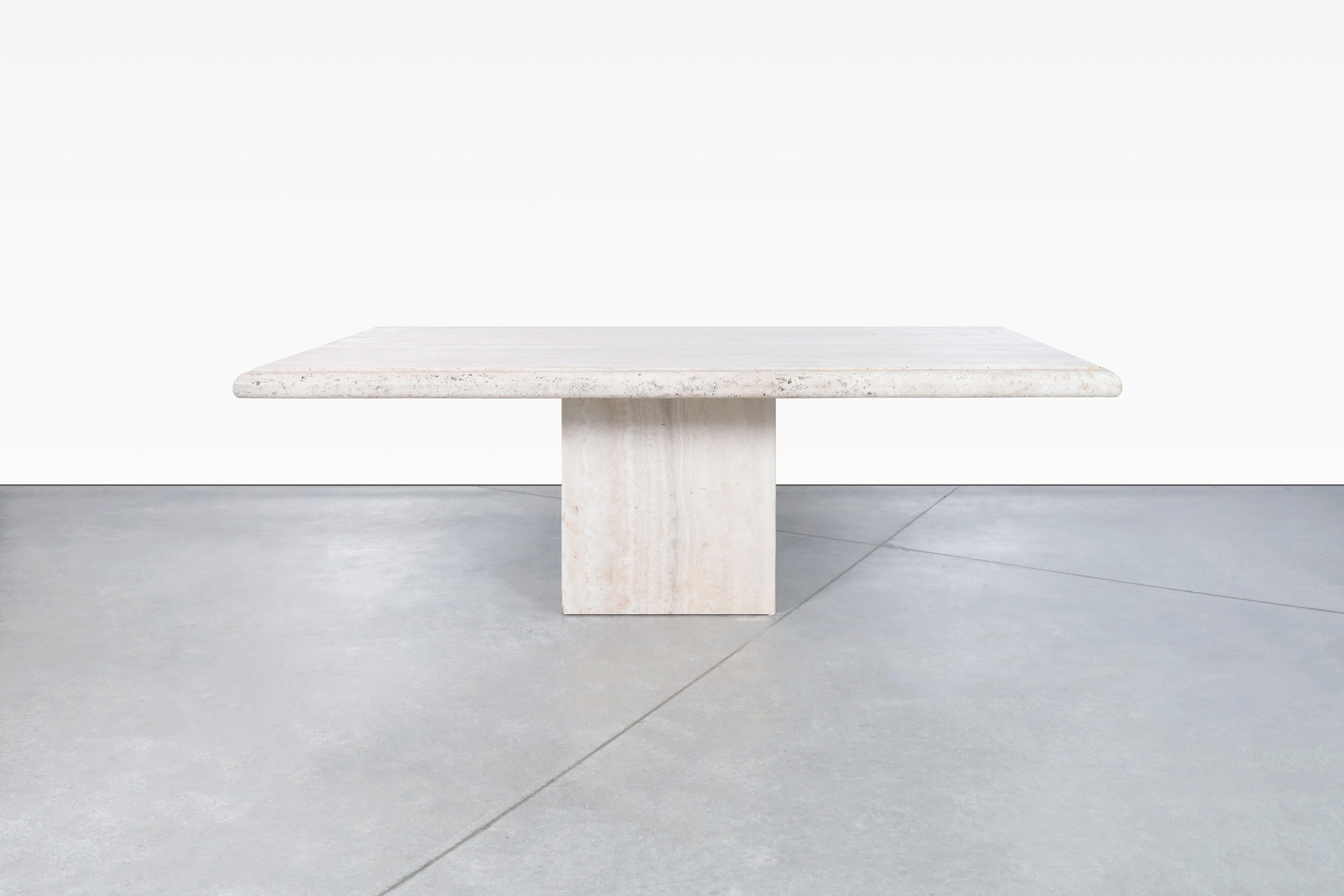 Wonderful vintage Italian travertine dining table by Stone International and manufactured in Italy, circa 1970s. This table has a design typical of the time and the place of manufacture, where the minerals that make up the travertine stone stand out