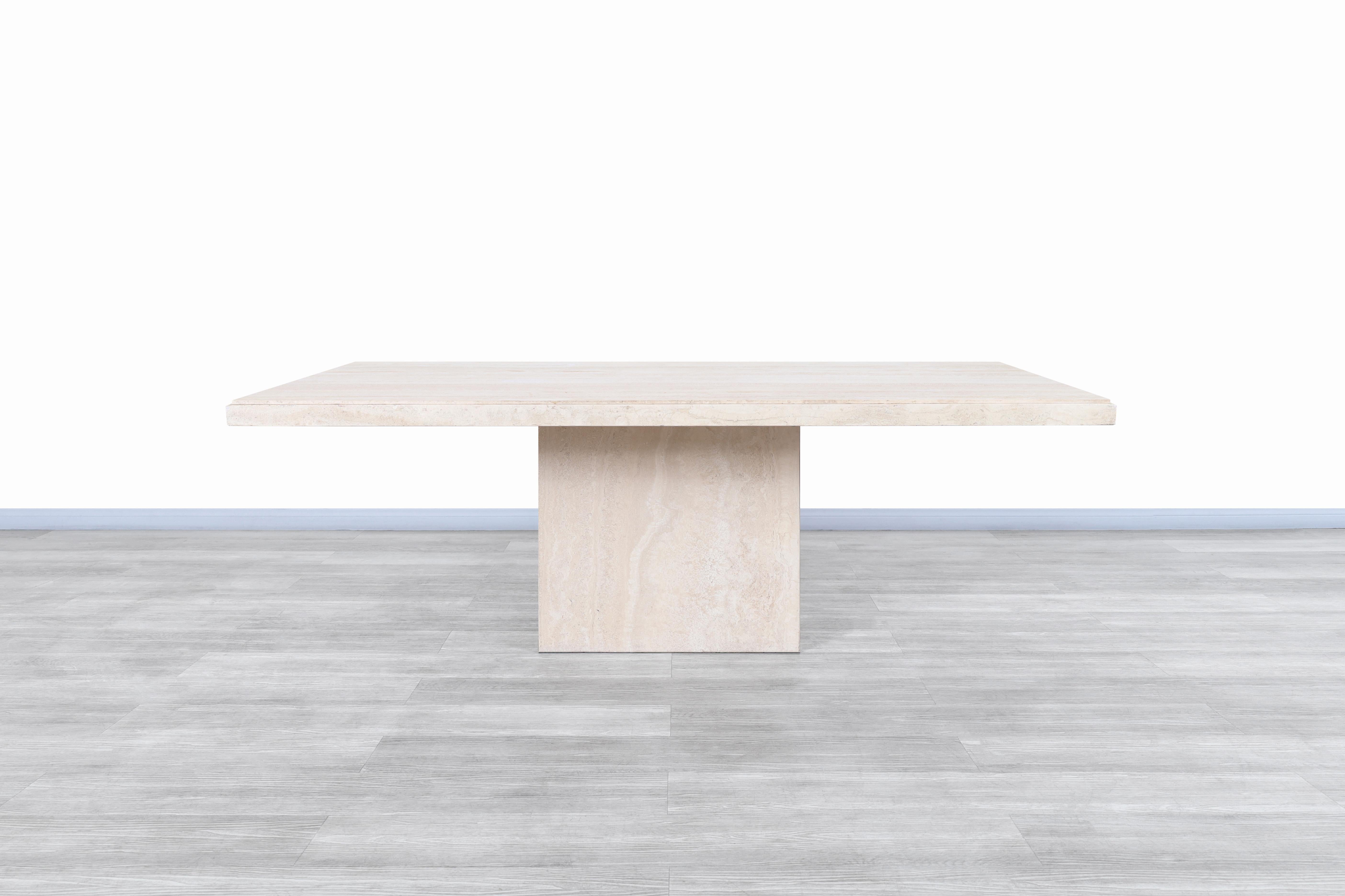 Exceptional vintage modernist travertine dining table / conference table manufactured in Italy, circa 1970s. This table features a gorgeous rectangular travertine top that sits over an extremely sturdy base and is complemented by the natural