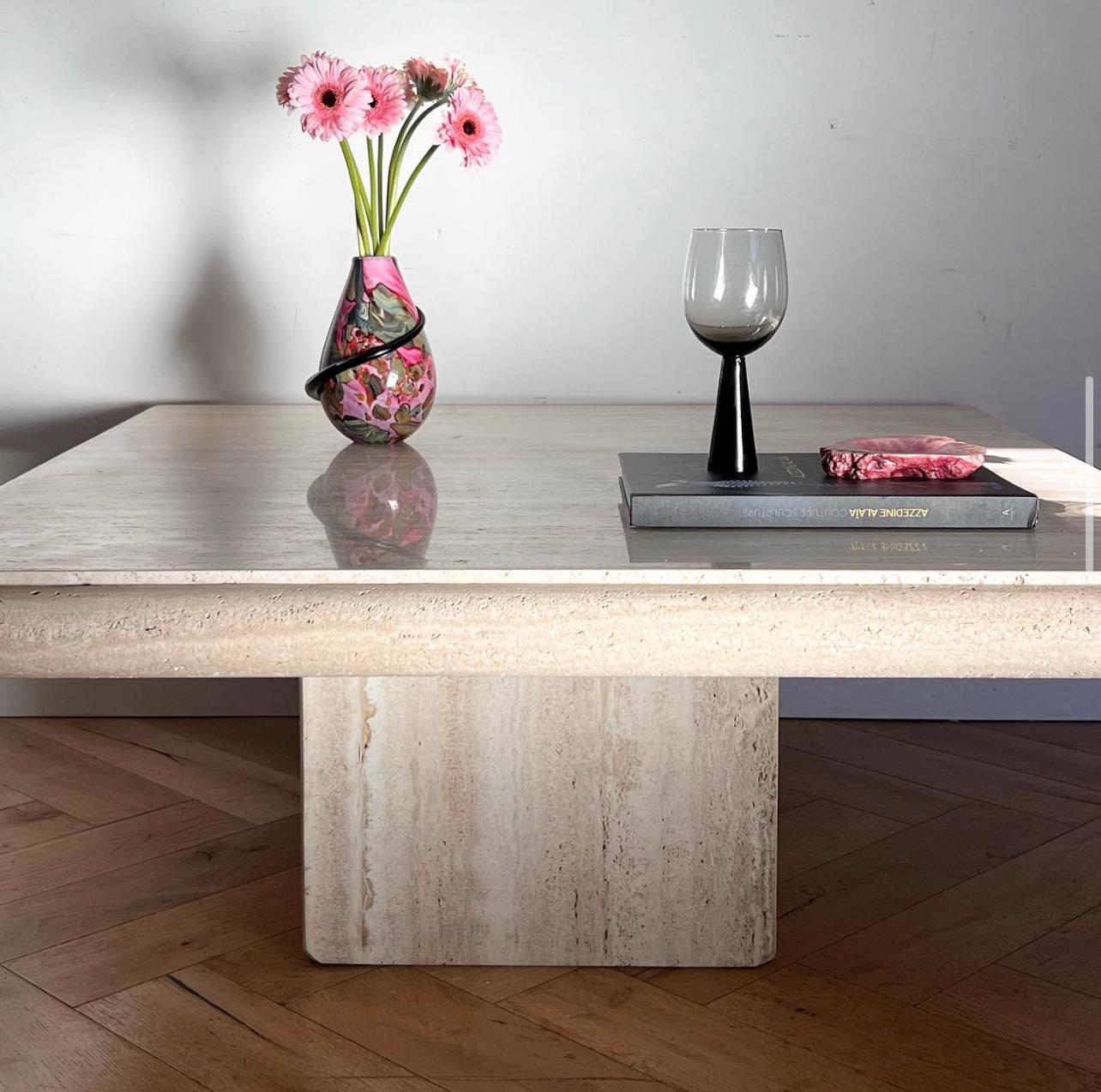 A statement vintage Italian travertine coffee table by renowned maker Stone International, circa early 1970s. Made in Florence, Italy. Featuring a thick bullnose edge on the top and shaved corners on the base, this table showcases the exquisite