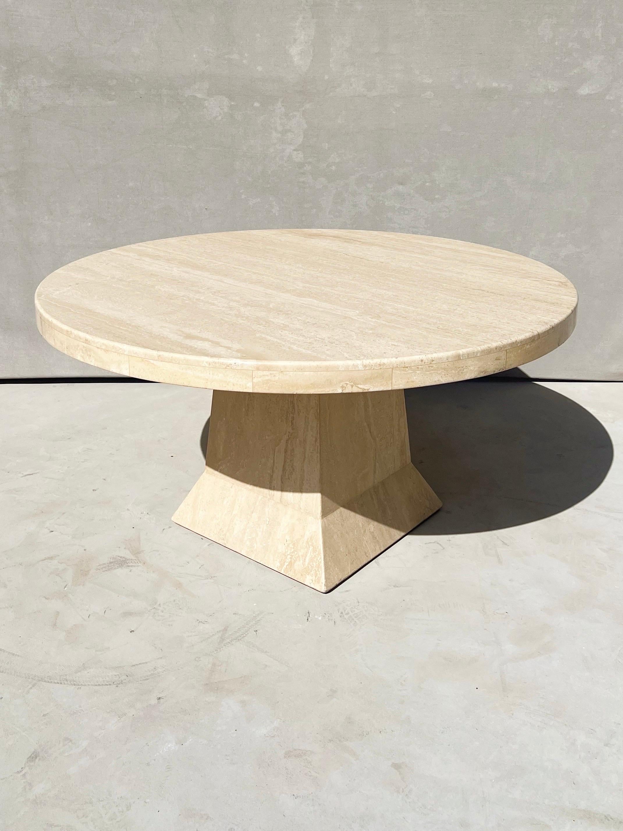 Vintage Italian Travertine round dining table with sculptural base.

An Italian travertine round dining table with even veins in colors of pearl, white, cream, soft beige, almond and cashew.

This dining table has a light to medium gloss which